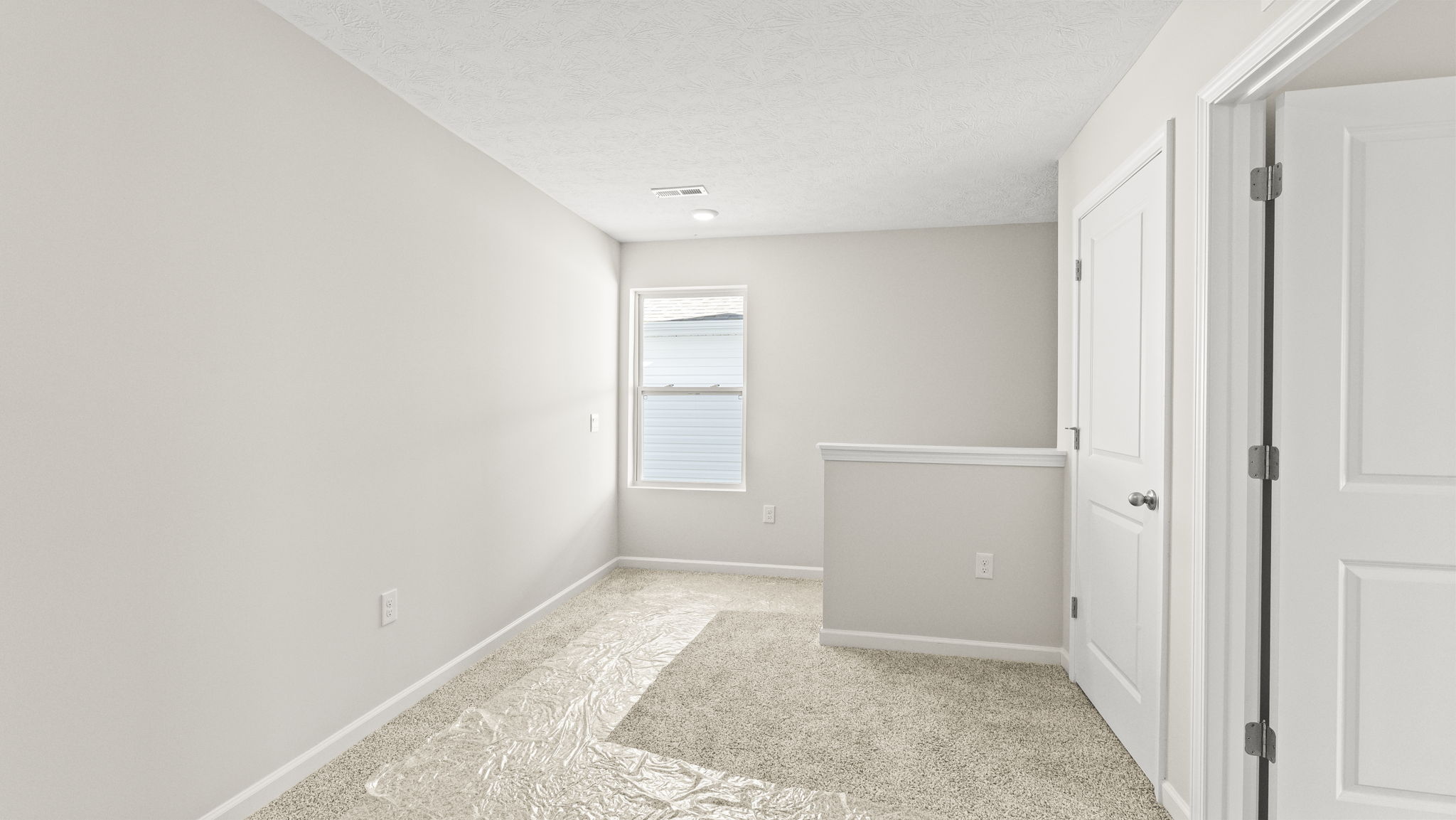 Upstairs landing area with carpet and window
