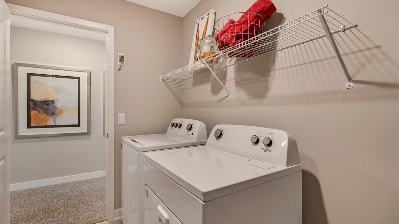 Upstairs laundry room with whirlpool washer and dryer.