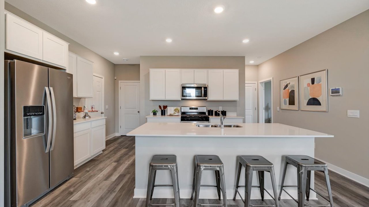 full view of the kitchen with white cabinets and countertops and whirlpool appliances.