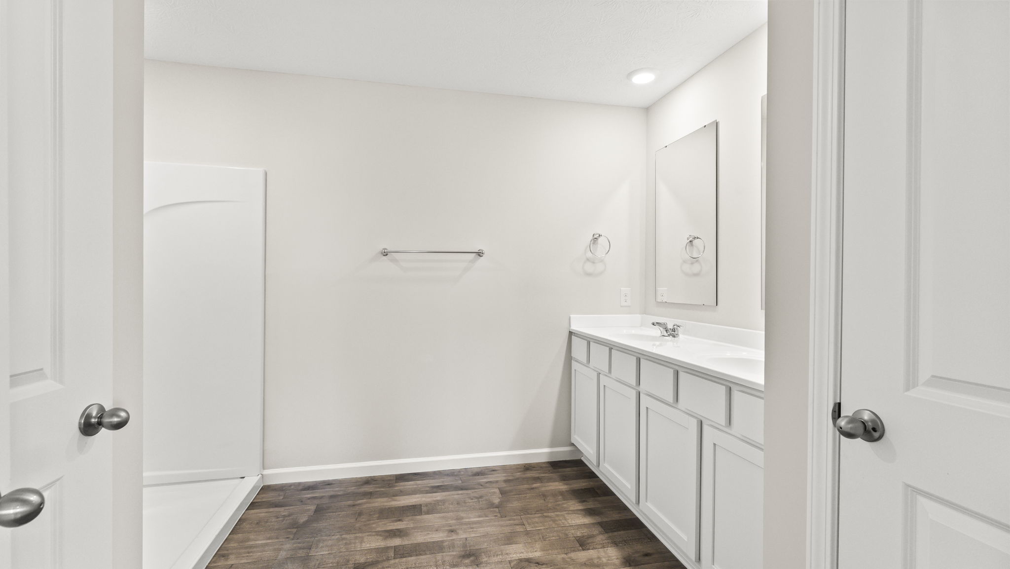 Primary bathroom with dual vanity sink and wa-in shower