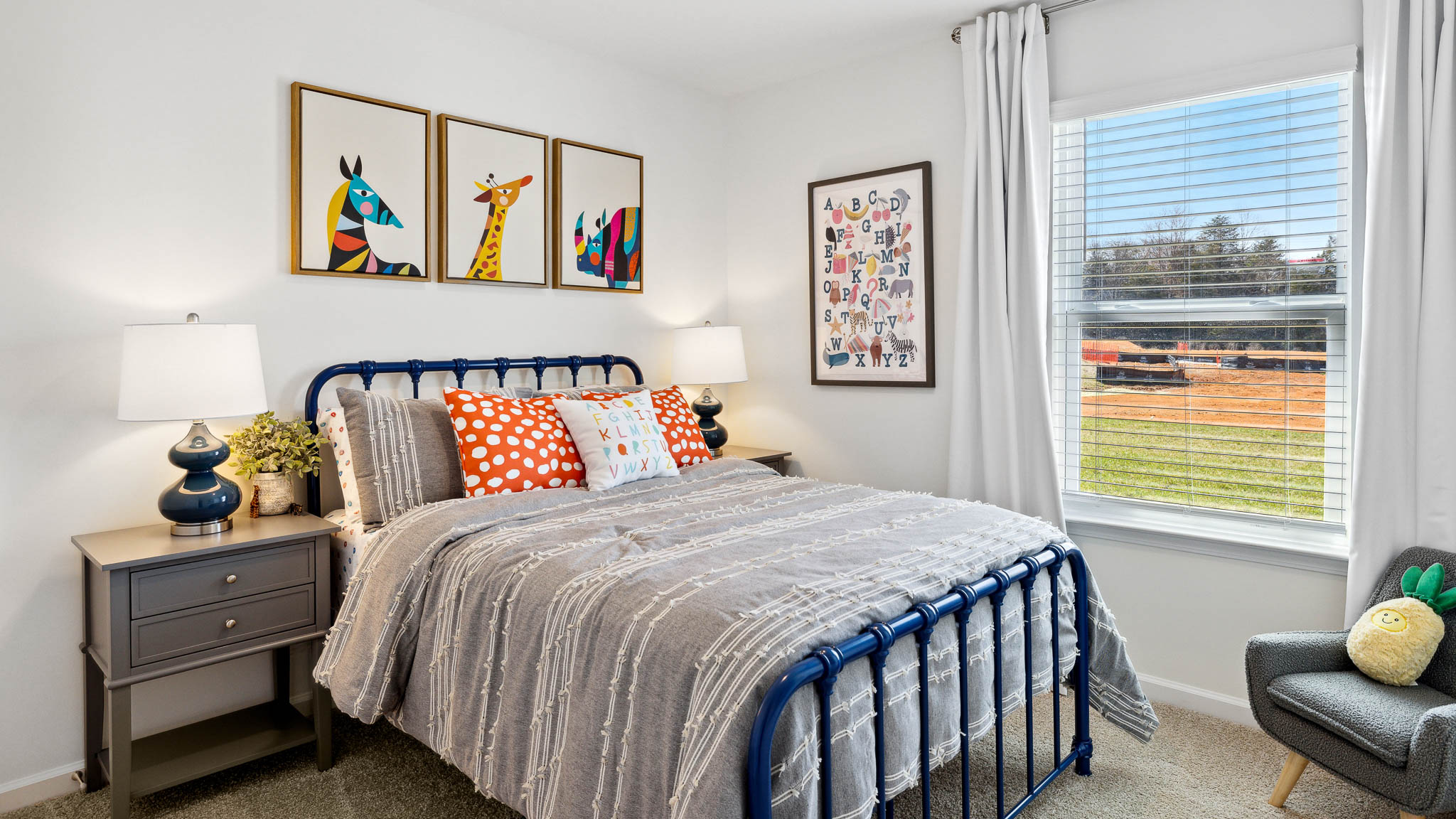 Full bedroom with blue, beige, and orange color palette.