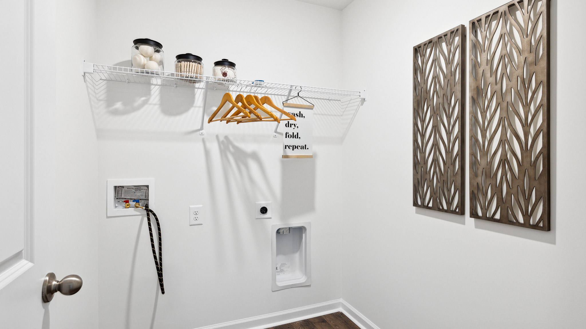 Laundry room with washer/dryer inlets and wire shelving