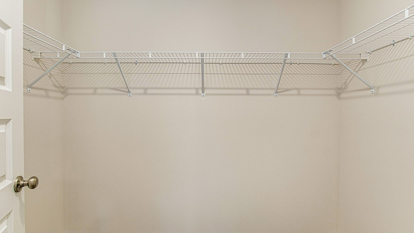 Walk-in closet with shelving.