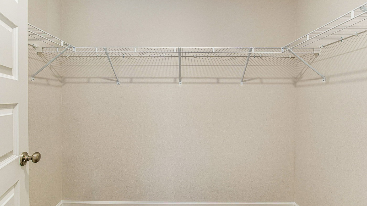 Walk-in closet with shelving.