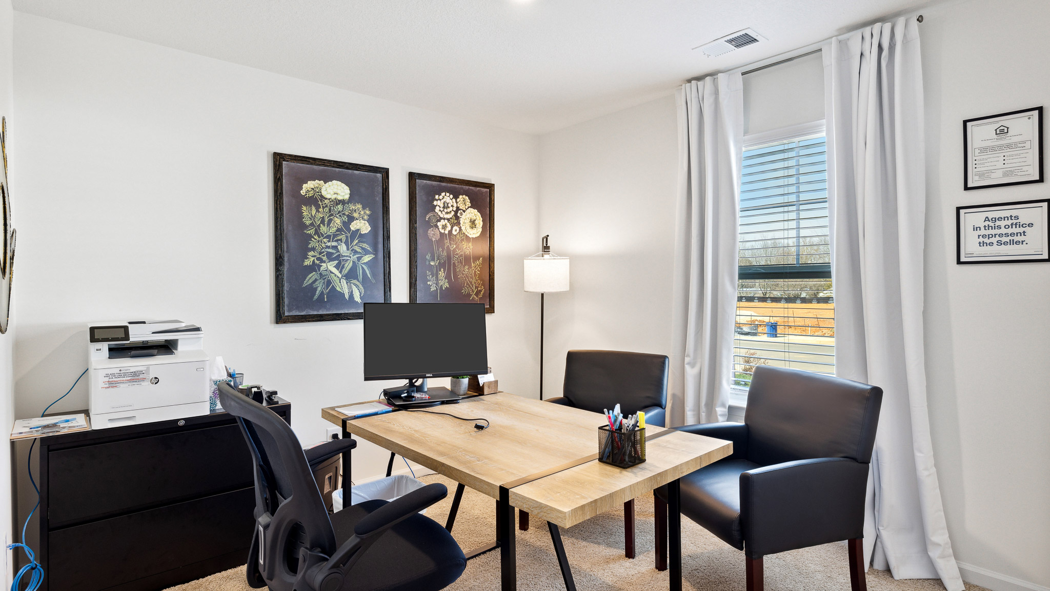 Flex room arranged as office with desk and computer.