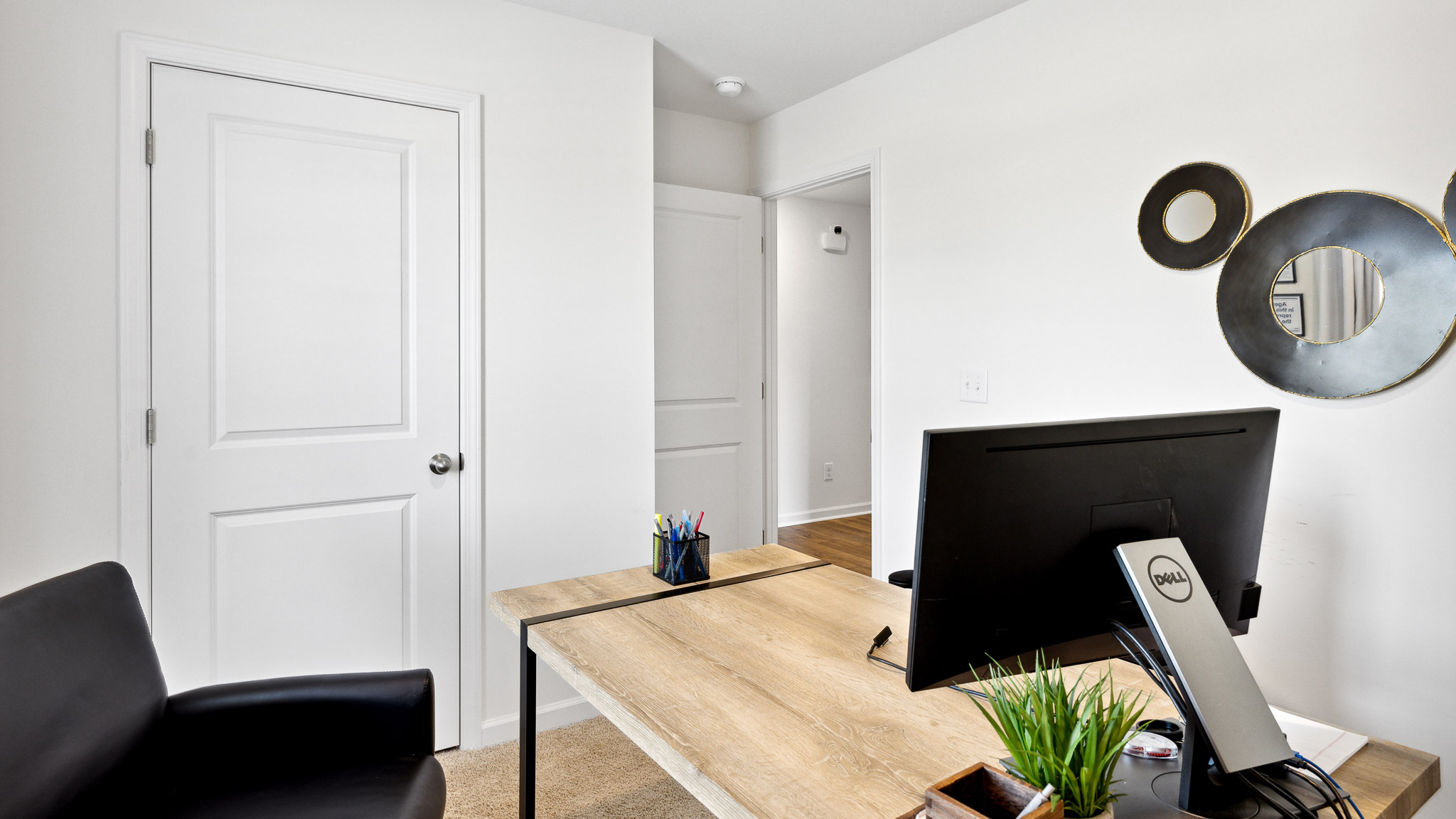 Flex room arranged as office with desk and computer.