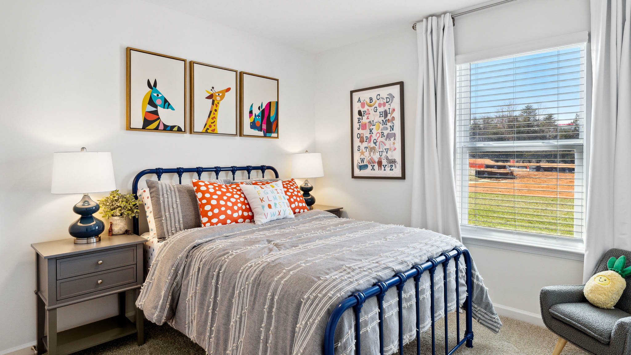 Full bedroom with blue, beige, and orange color palette.