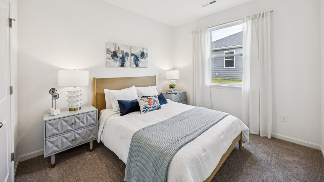 Bedroom with blue and white bedding