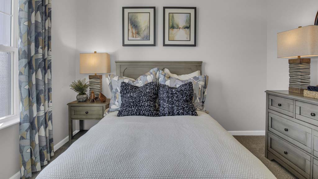 Close up on front bedroom pillows and side table.