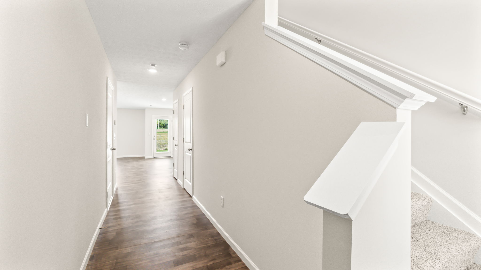 hallway foyer with view of great room and stairs