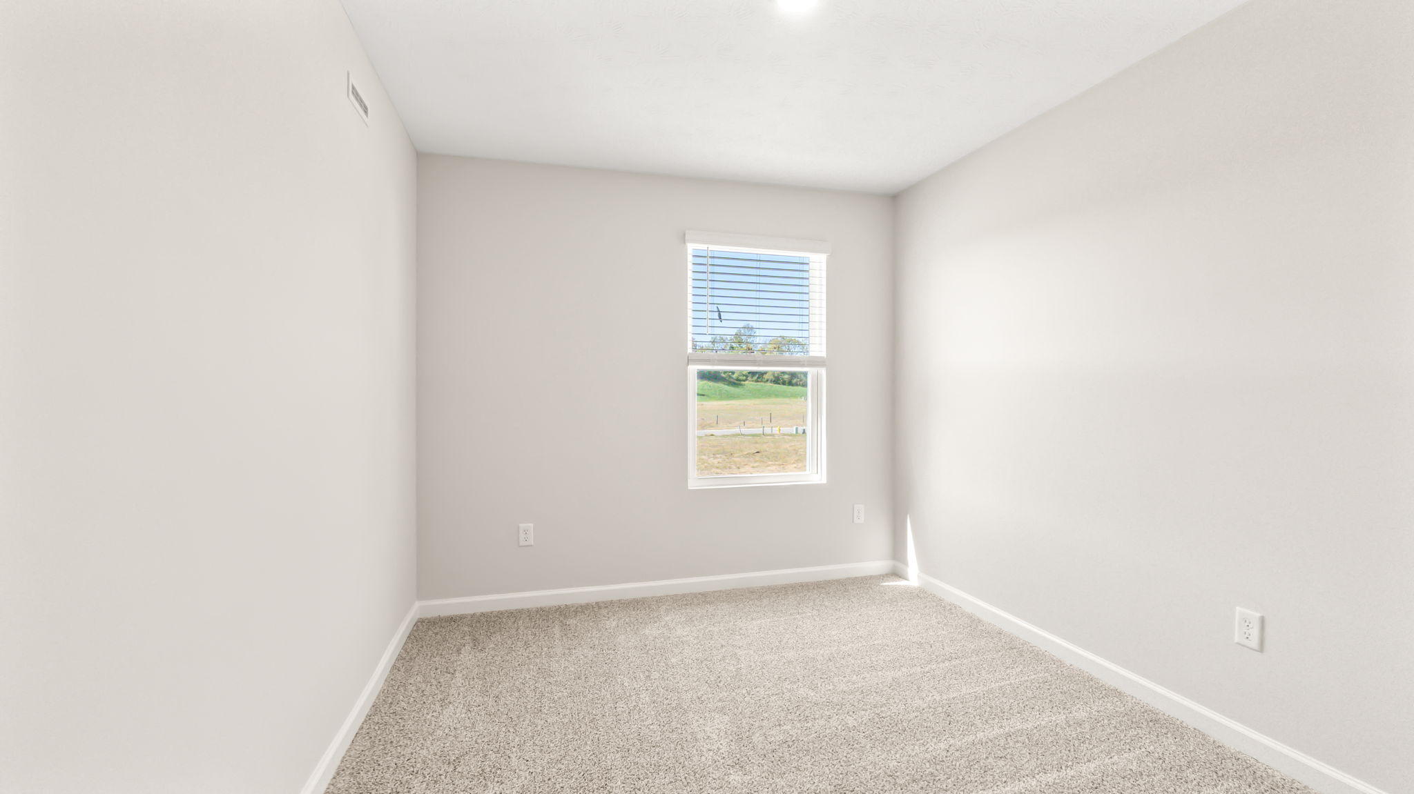 Carpeted bedroom with window