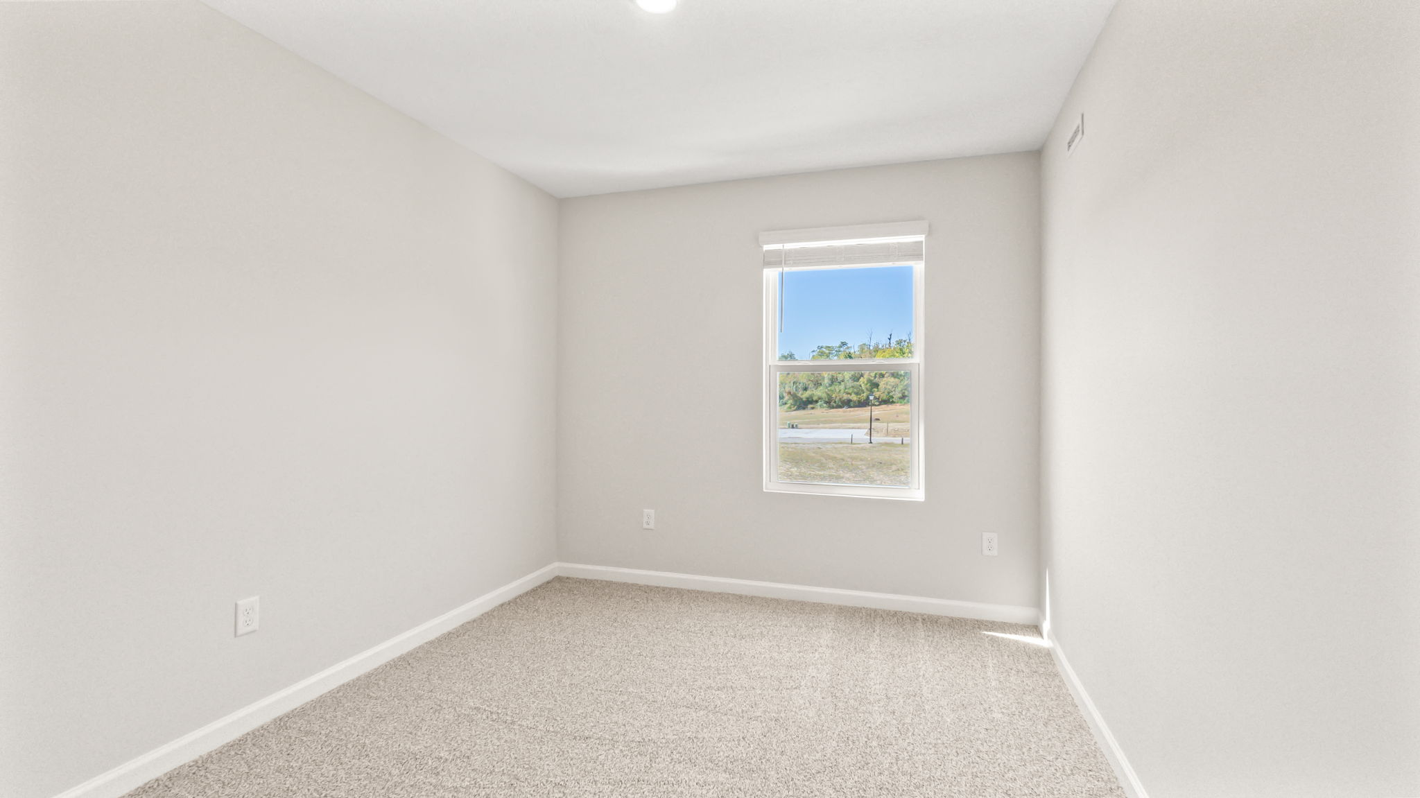 Carpeted bedroom with window