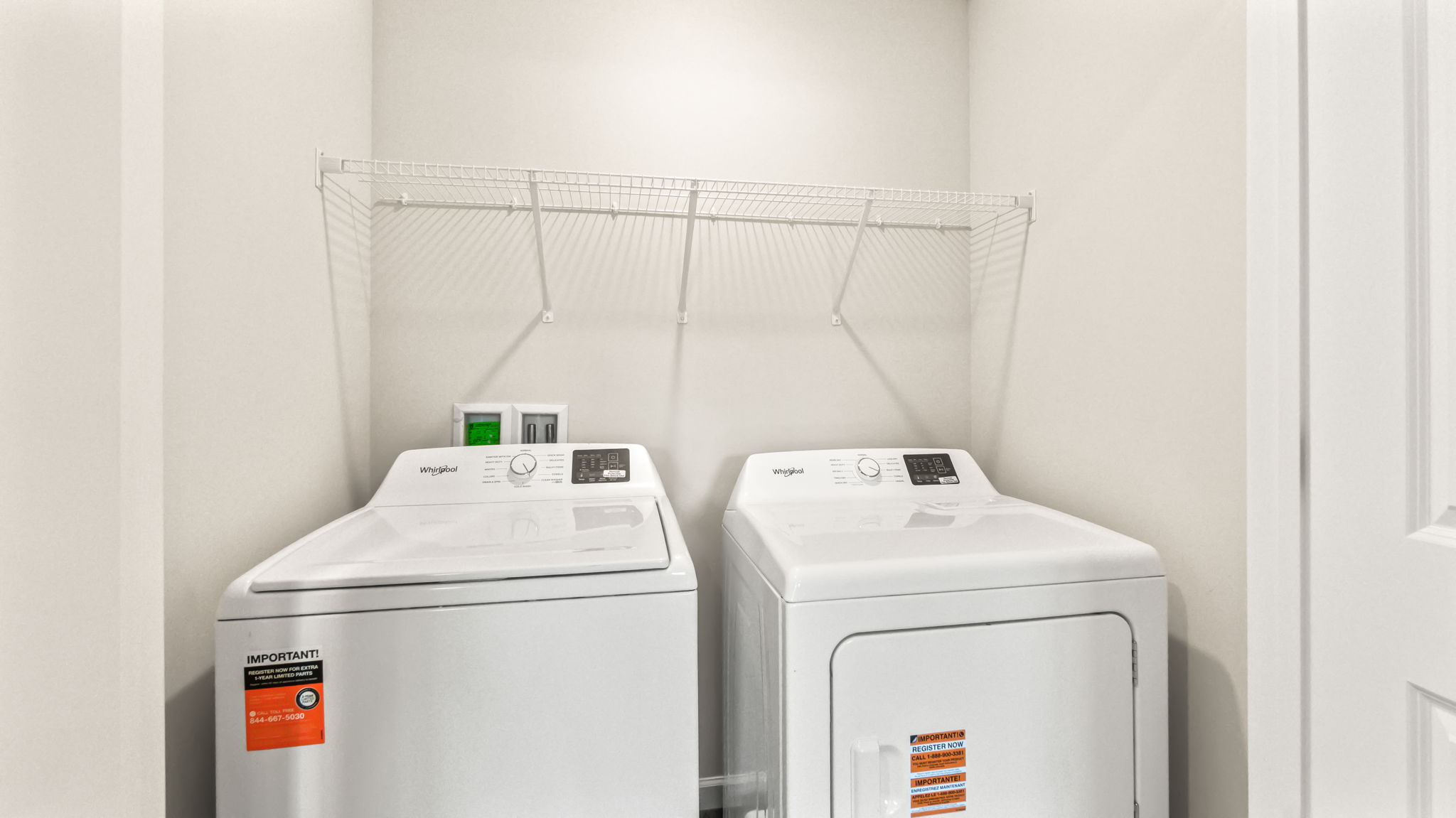 laundry area with washer/dryer and wire rack shelving