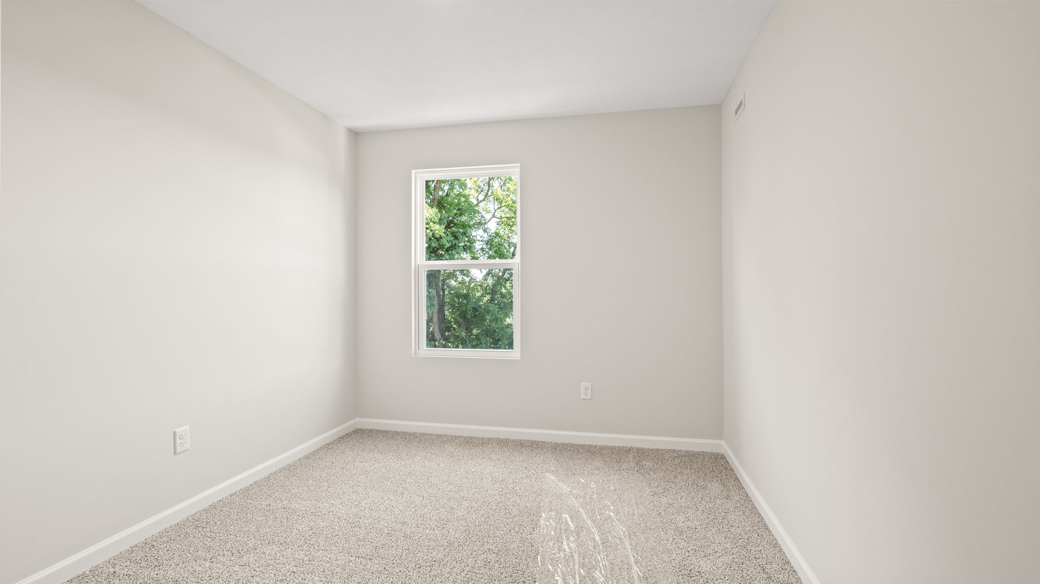 Carpeted bedroom with window
