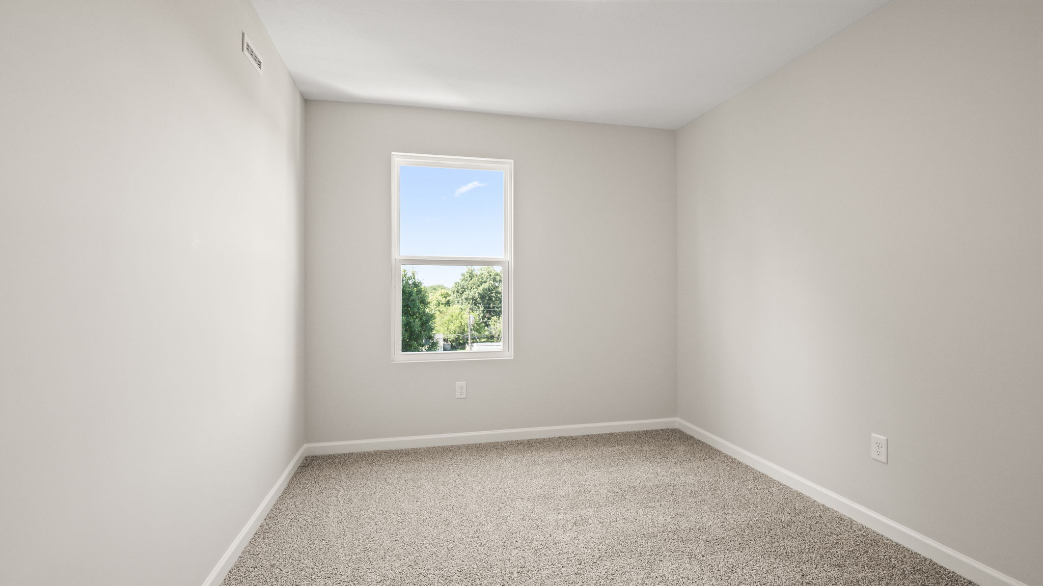 Carpeted bedroom with window