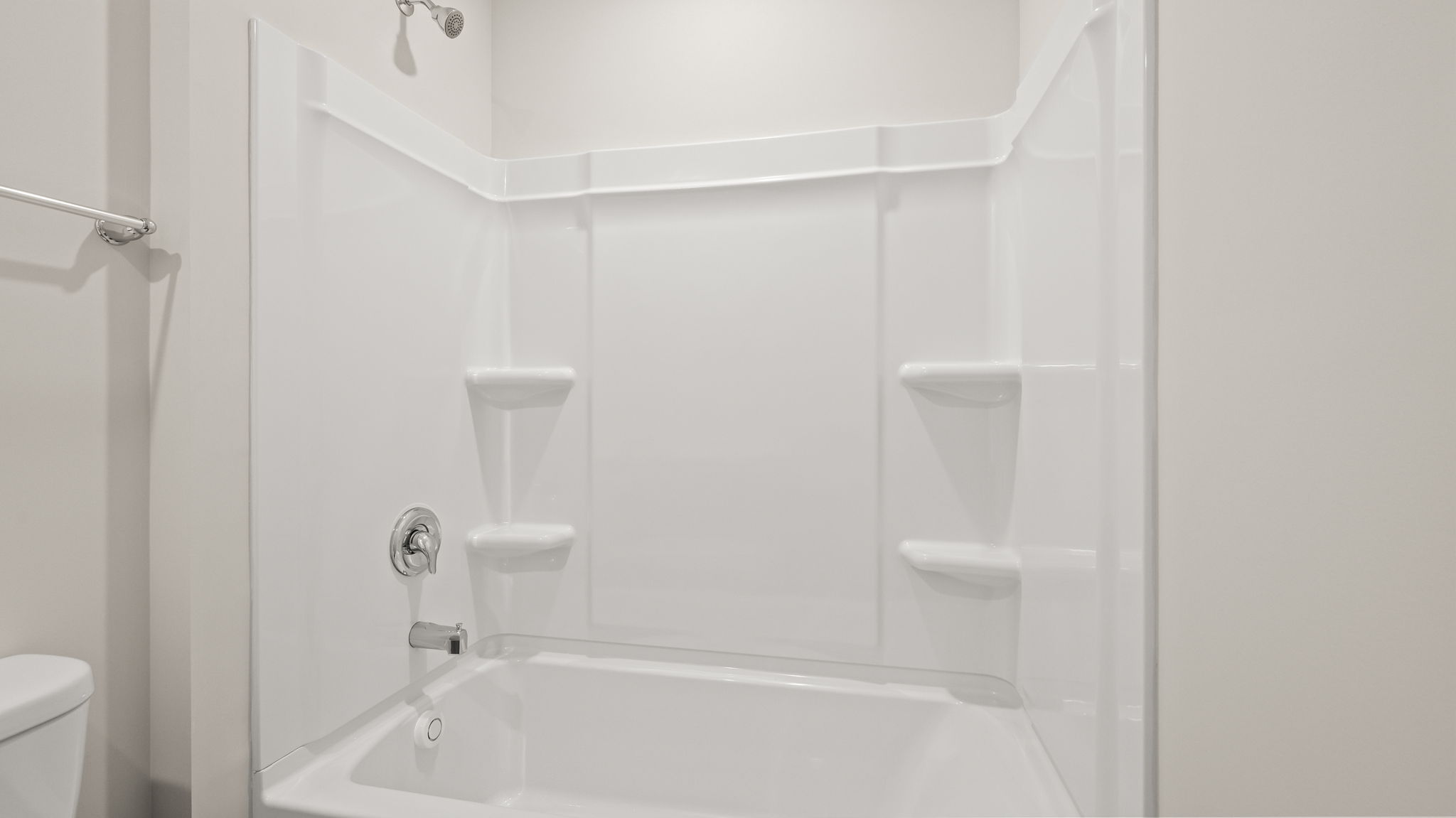 Bathroom tub/shower combo with tiered shelving