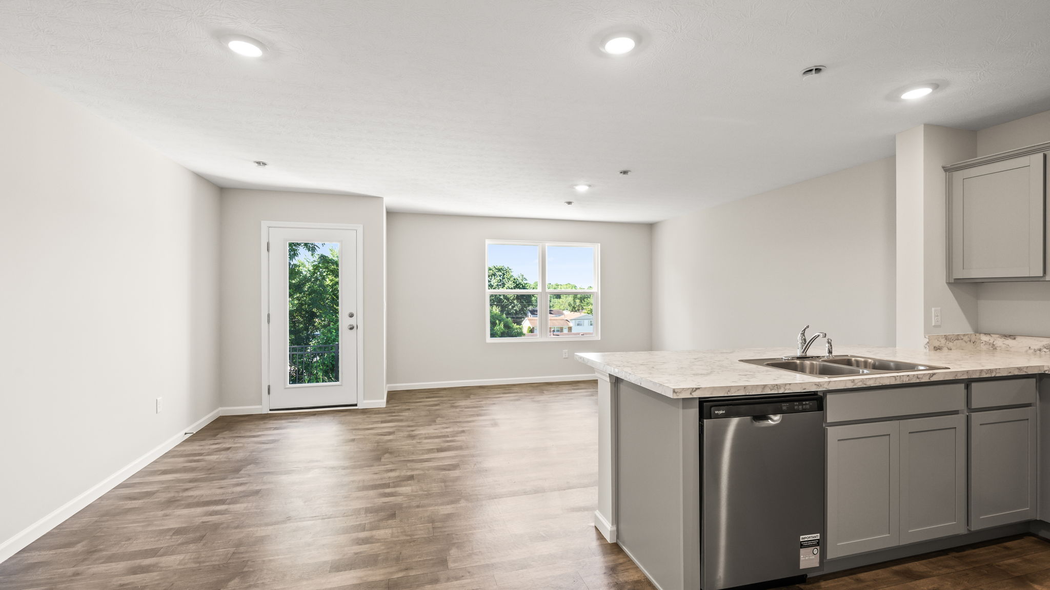 Wide angle image of great room from behind kitchen counter