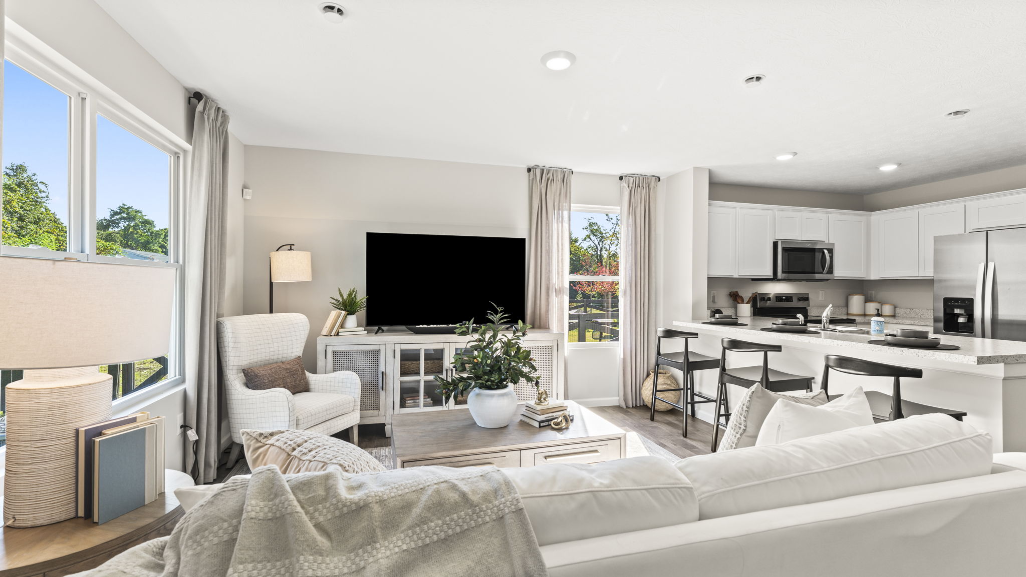Living room with comfy white couch, modern accents, and artwork.