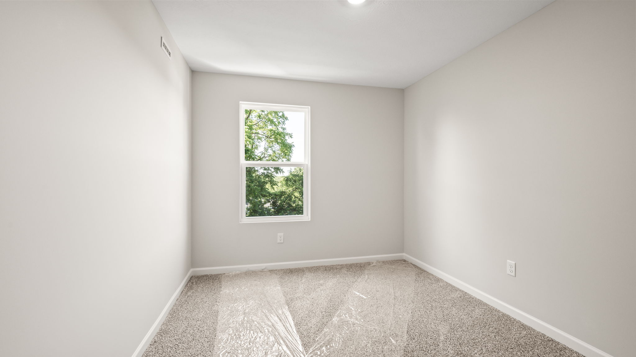 Carpeted bedroom with window