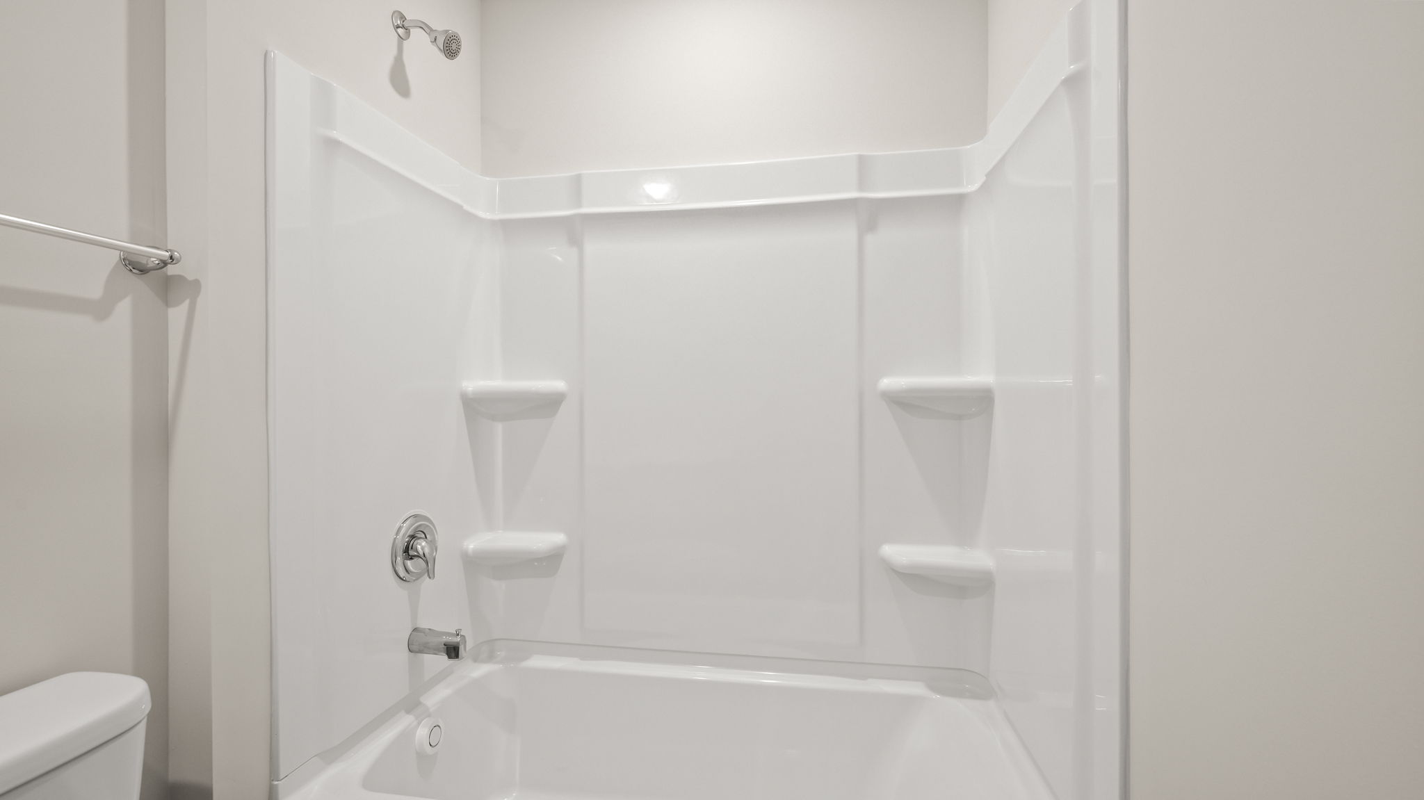 Bathroom tub/shower combo with tiered shelving