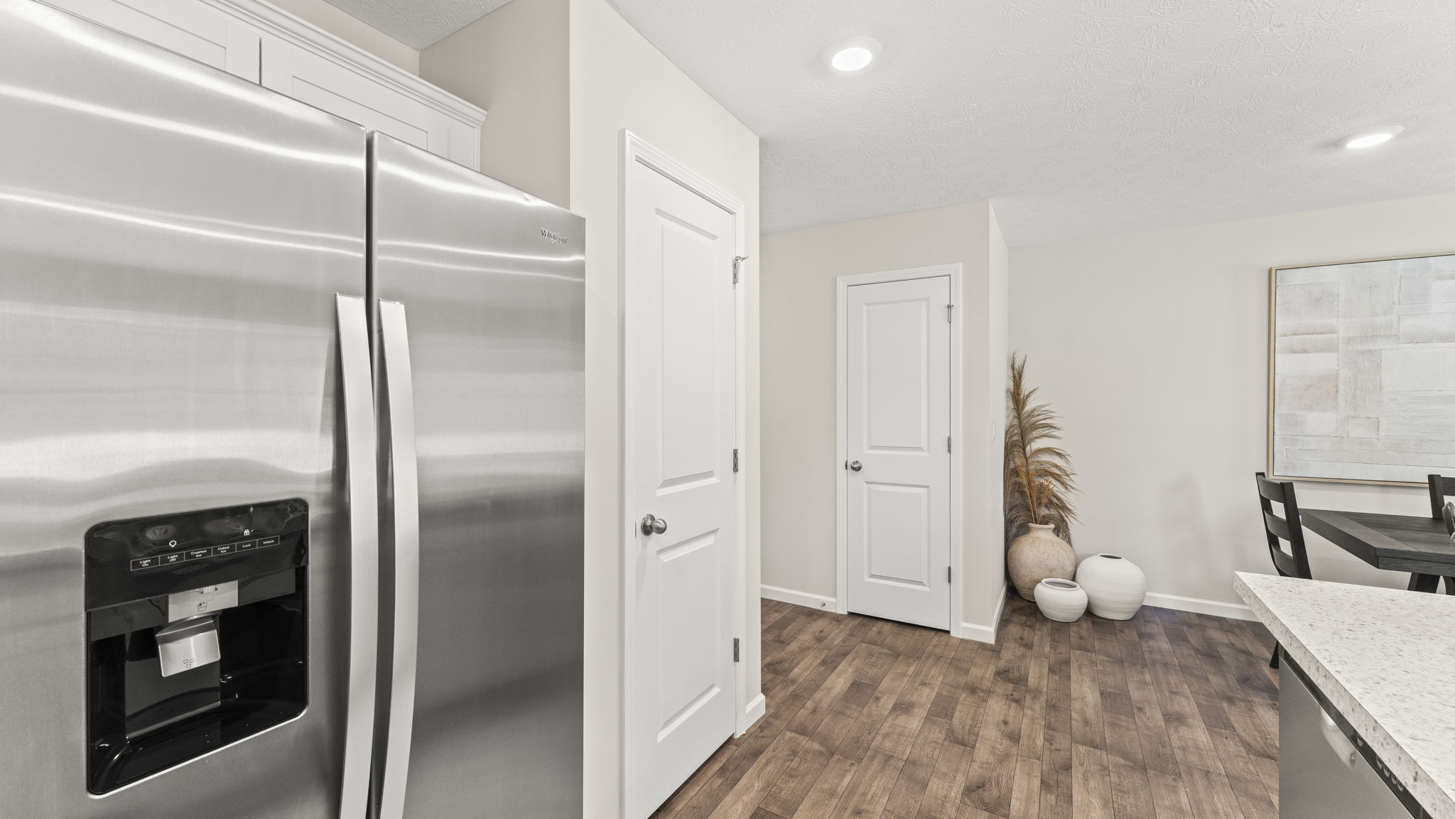 Refridgerator with pantry and storage closet doors.