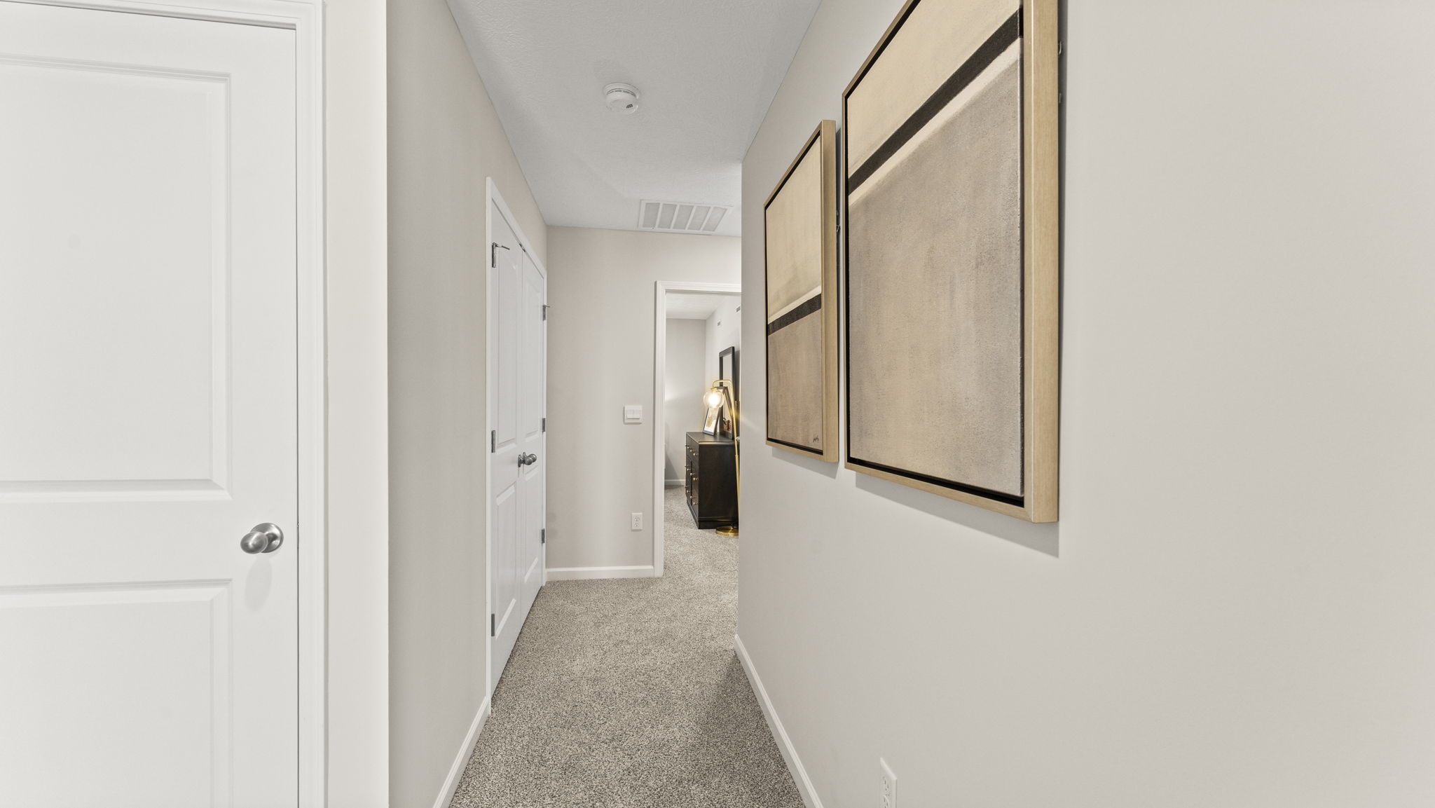 Hallway at the top of the stairs with view of the laundry room area.