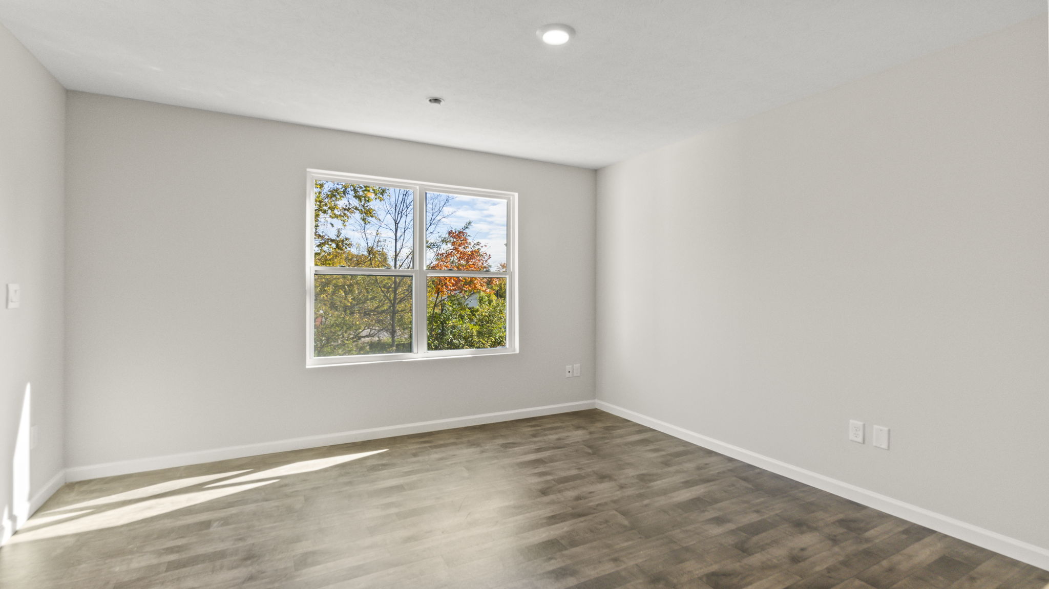 Full great room with window and multiple outlets.