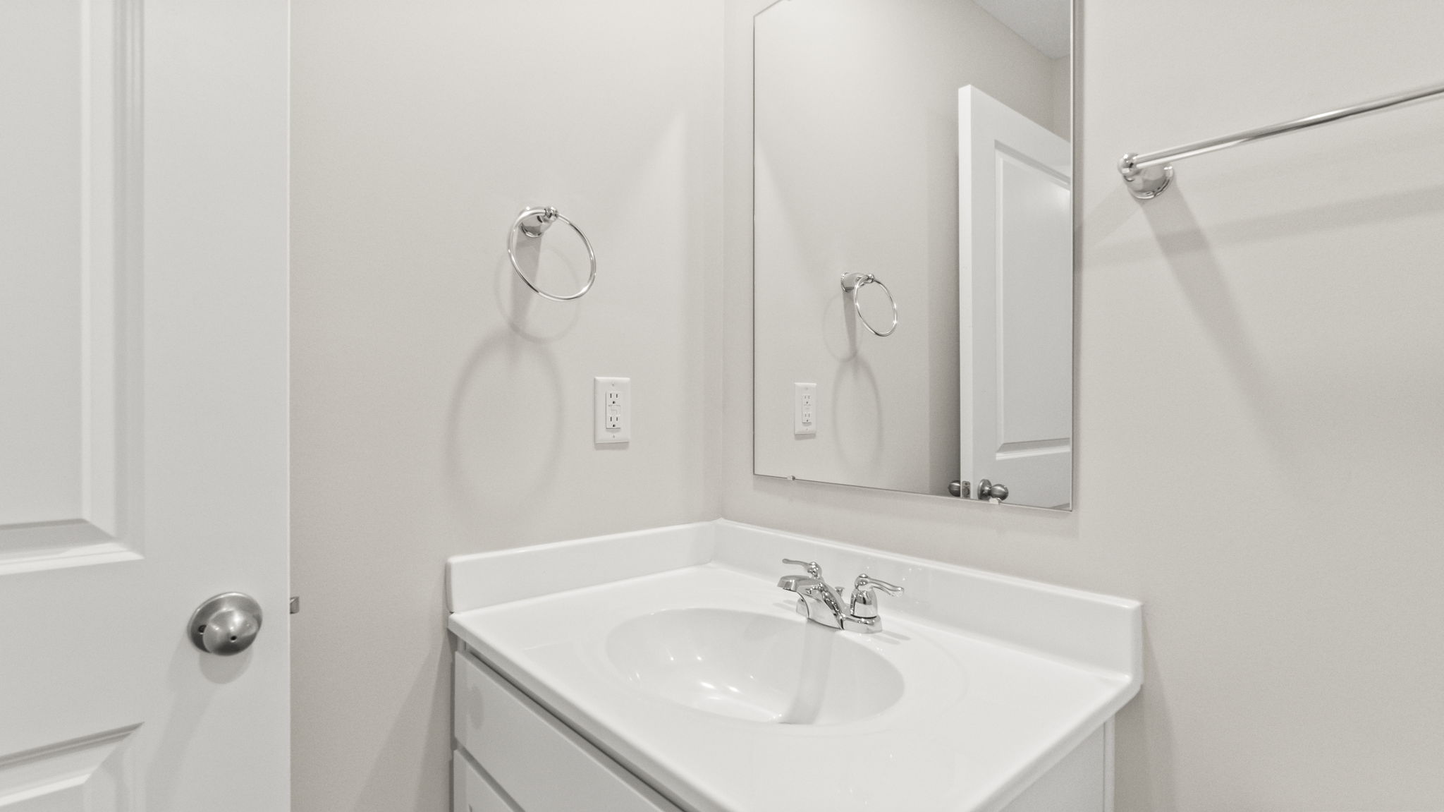 Closeup of sink and mirror in upstairs bathroom