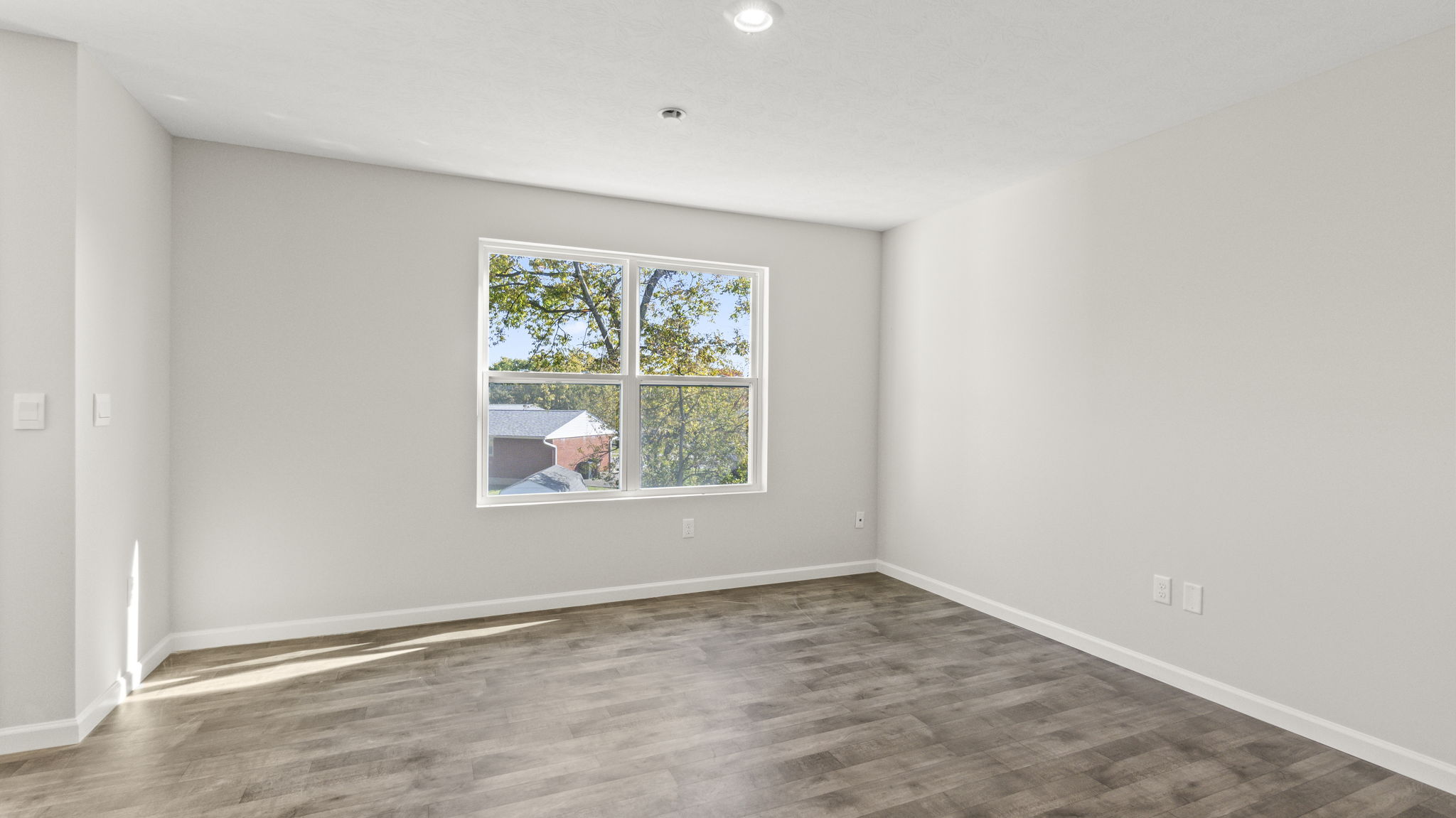 Full great room with window and multiple outlets.