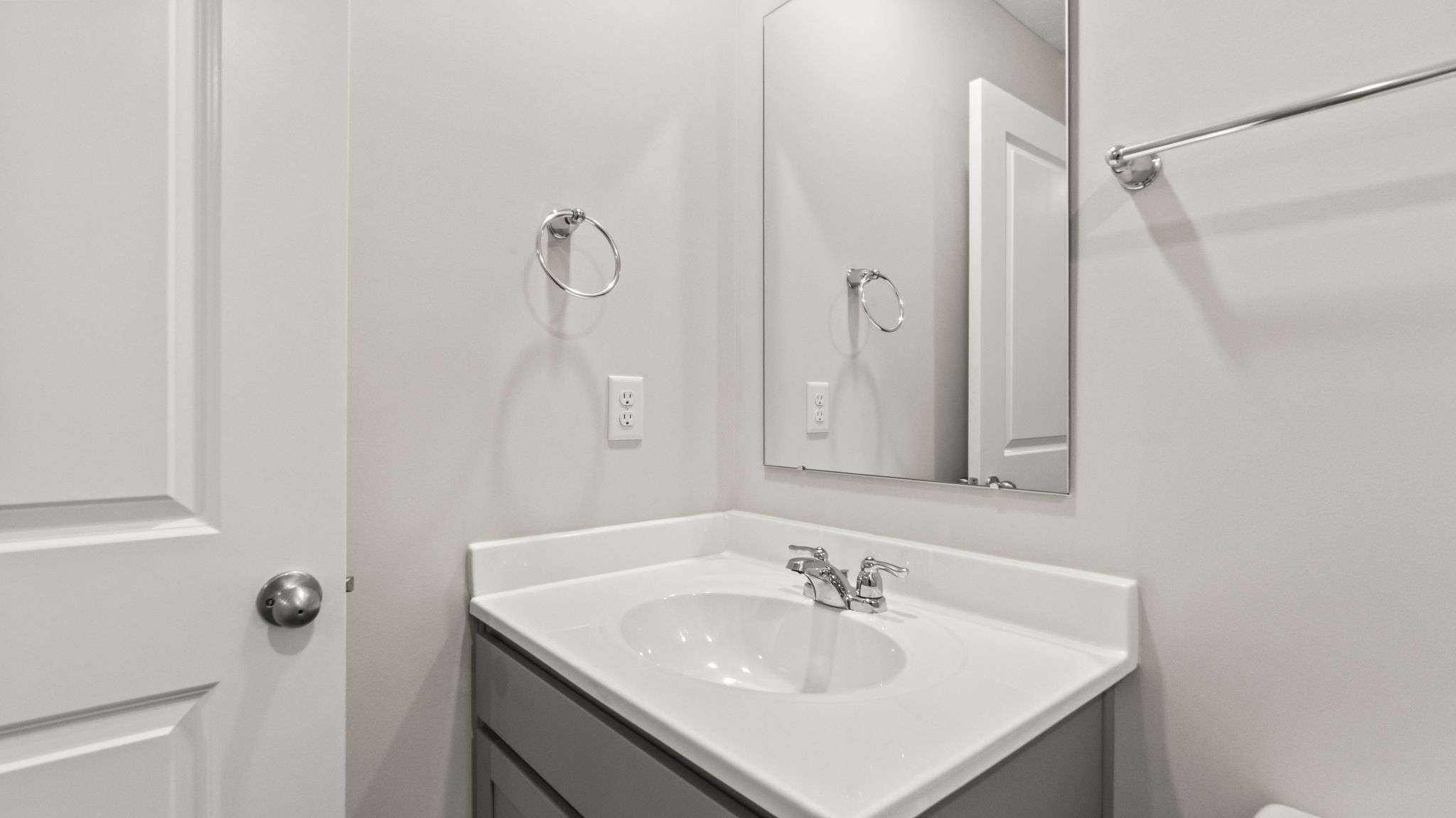 Closeup of sink and mirror in upstairs bathroom