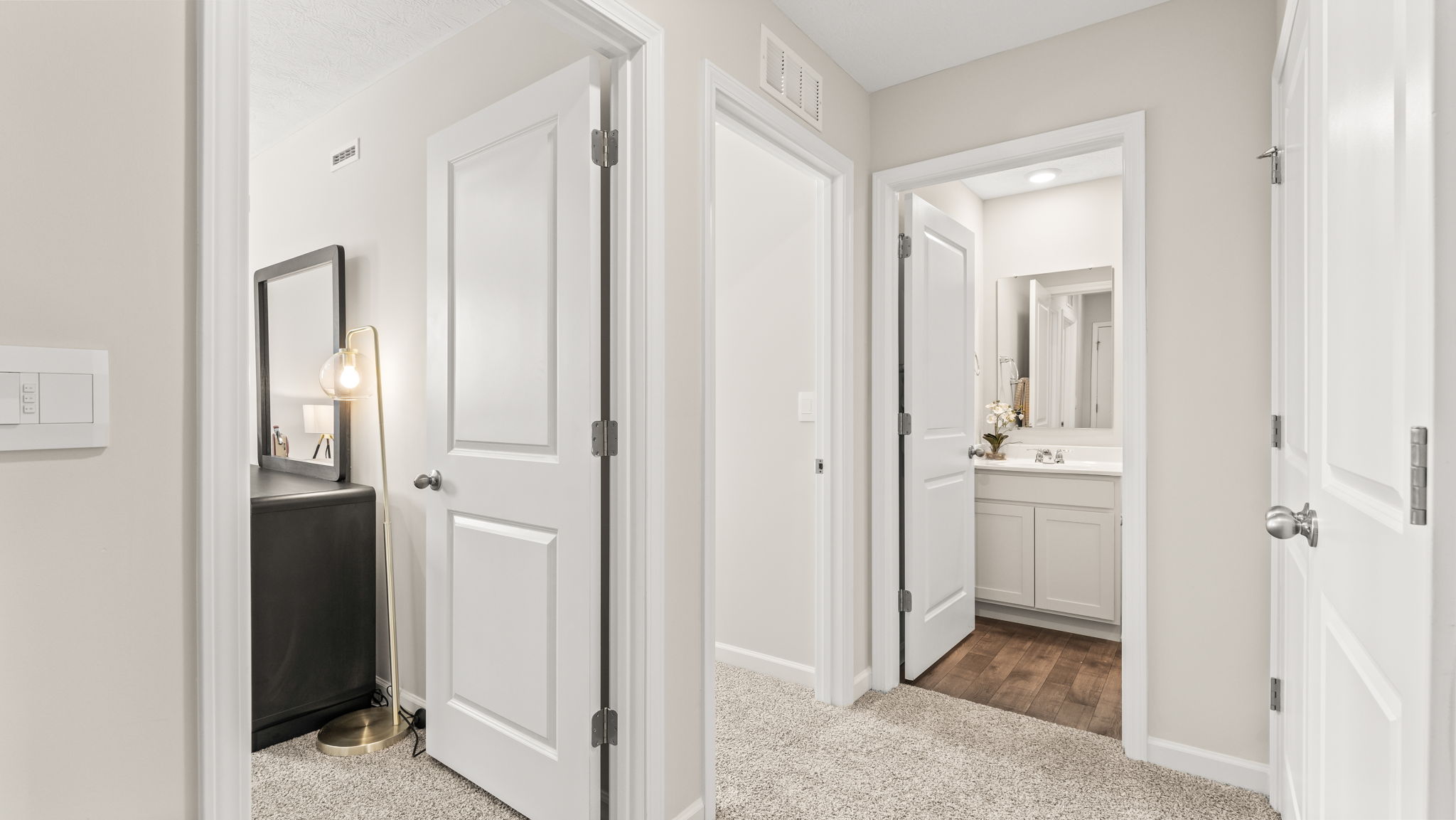 second-level hallway with view of the 2 other bedrooms and bathroom