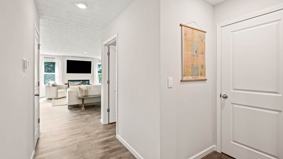 Hallway to Great room with door to laundry room.