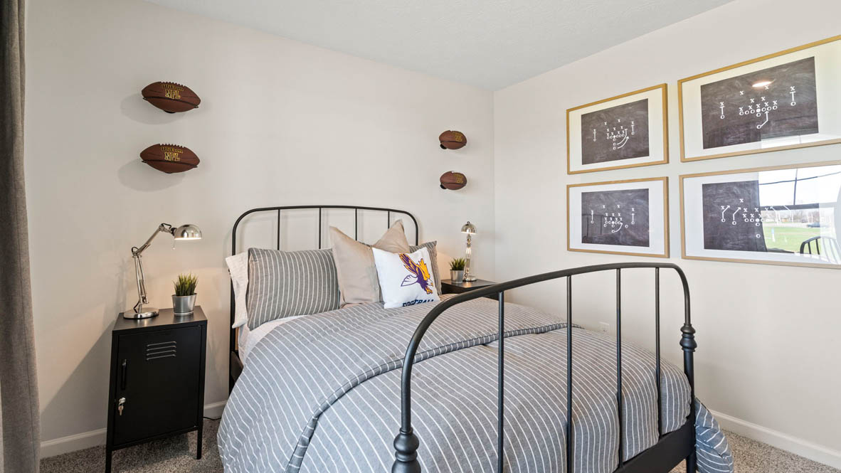 Close up of front bedroom bed with football decorations.
