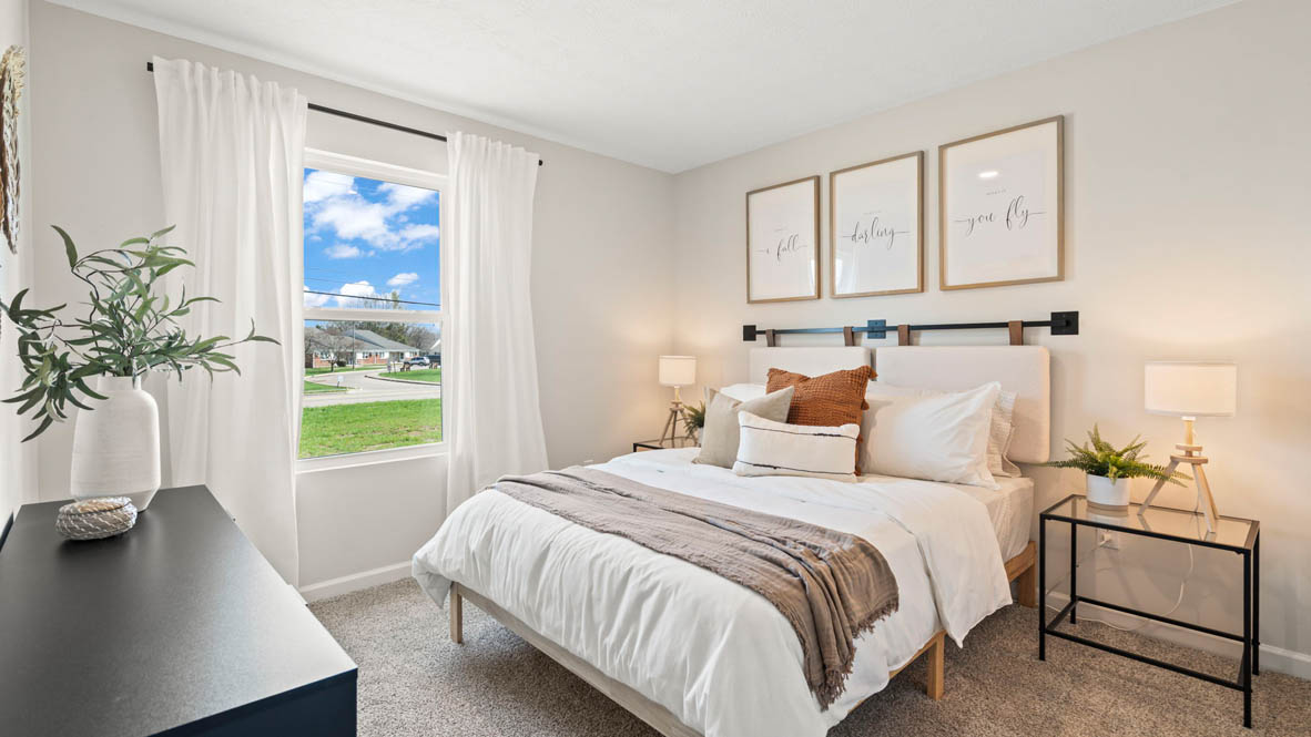 Side bedroom with beautiful decorations and large bed.