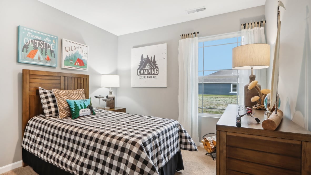 Boys bedroom with wooden furniture and modern art.