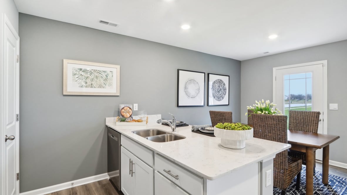Kitchen pensulia with modern art and dining table.