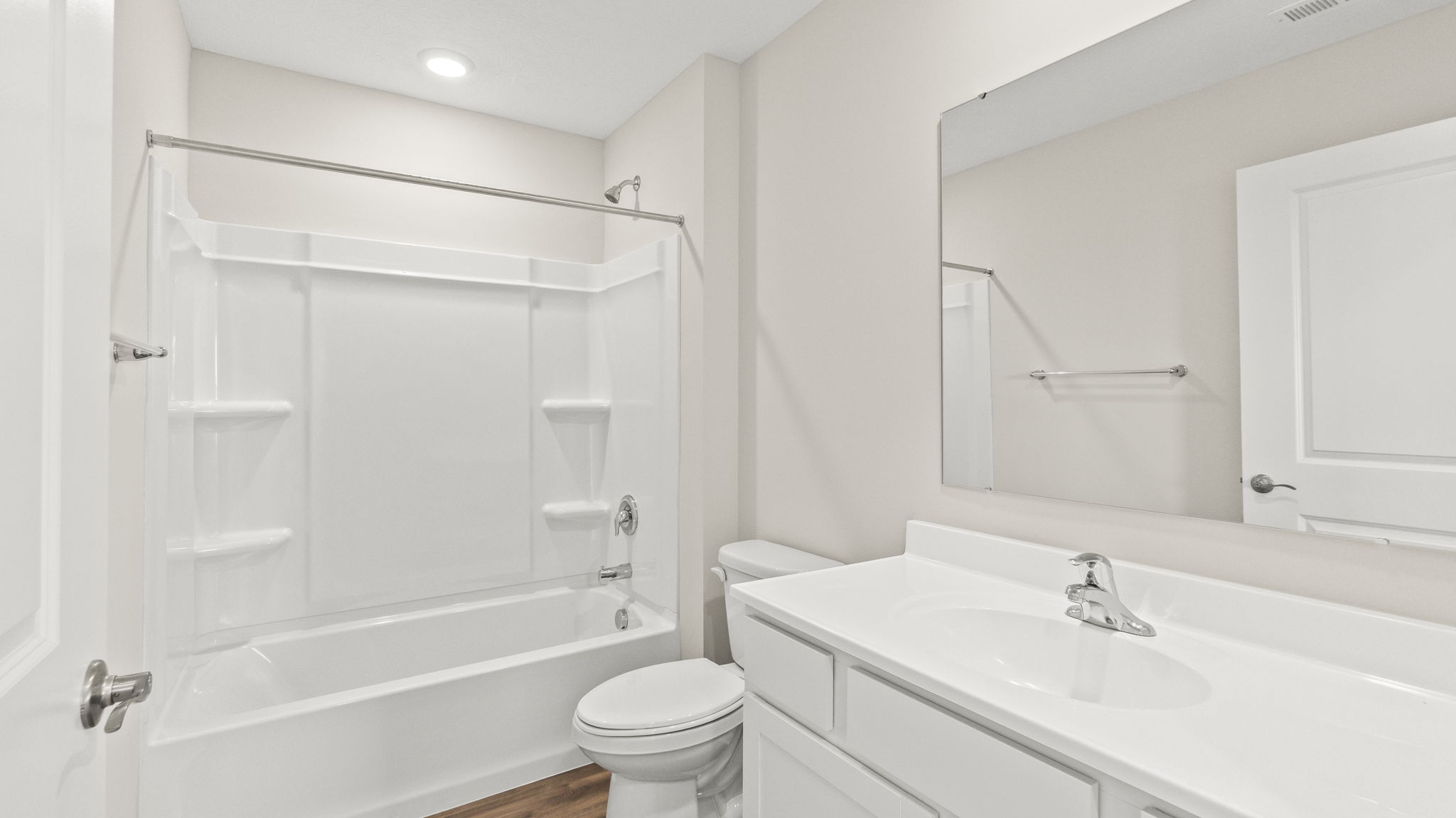 Bathroom with toilet, shower, tub, sink, and mirror