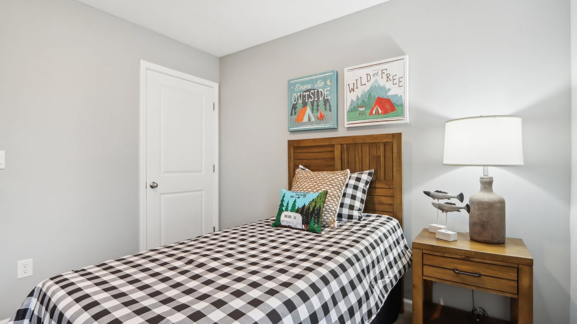 Boys bedroom with wooden furniture and modern art.