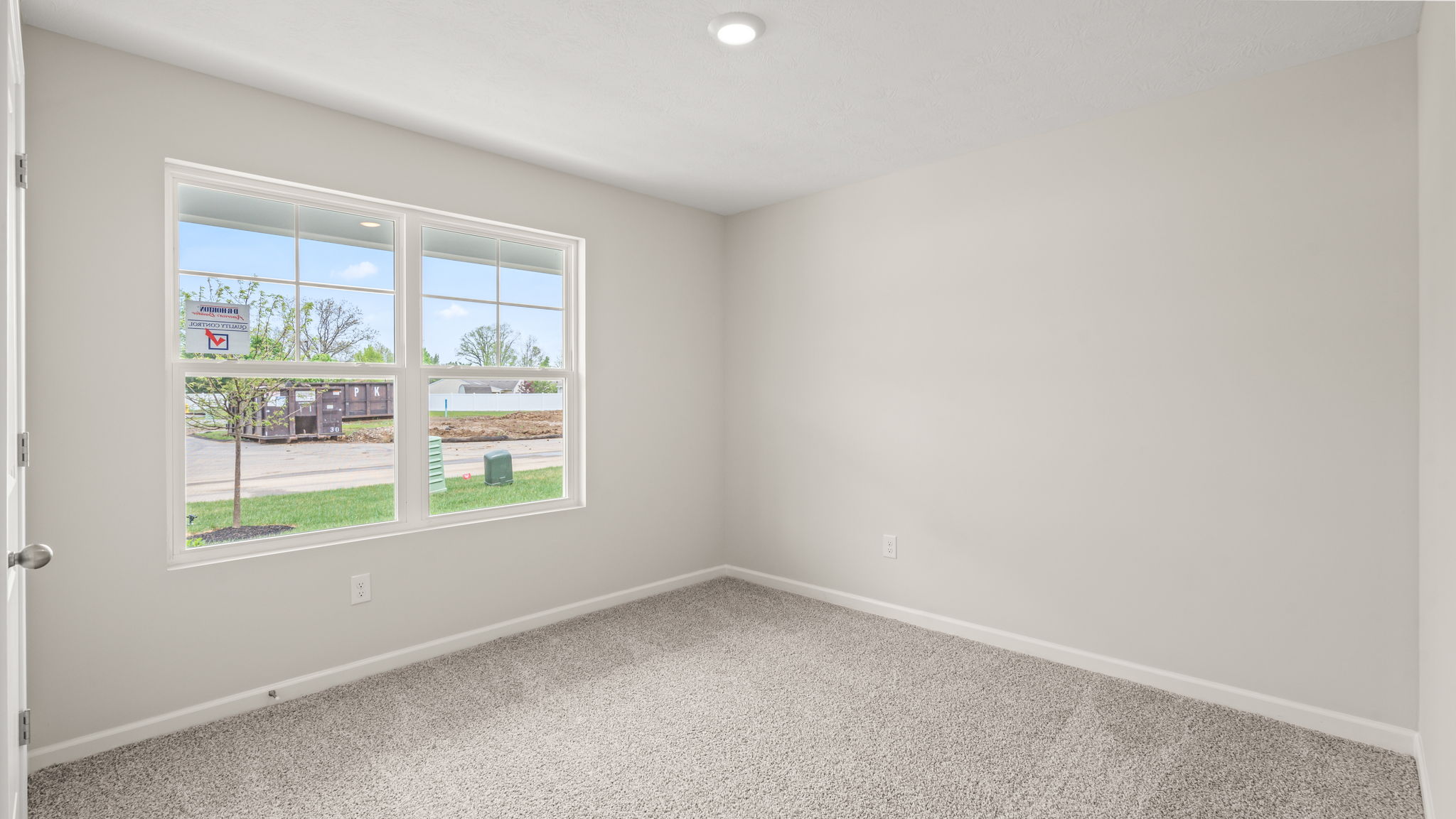 Front bedroom with large window for natural lighting.