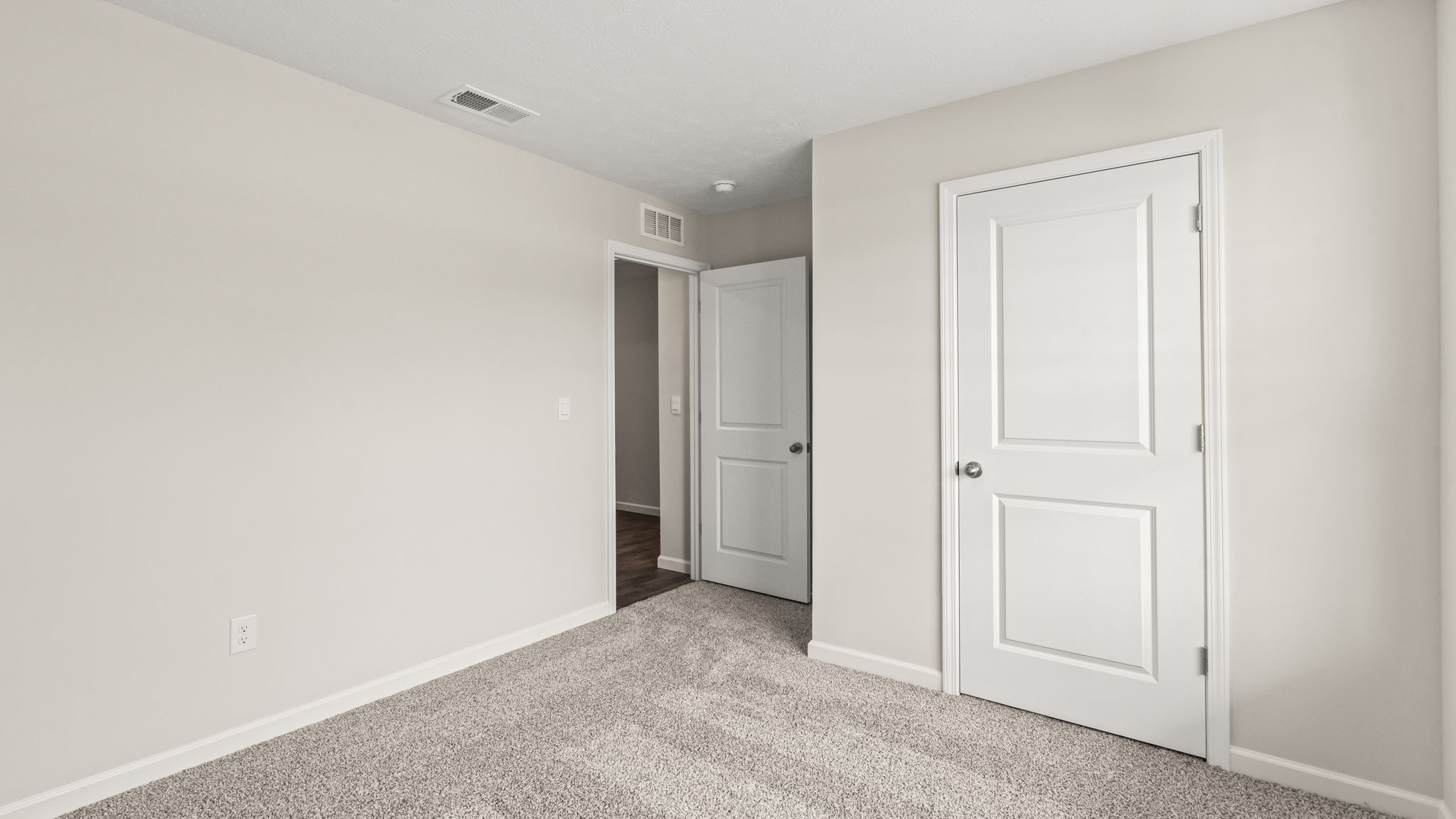 Bedroom with carpeted floors and a closet.