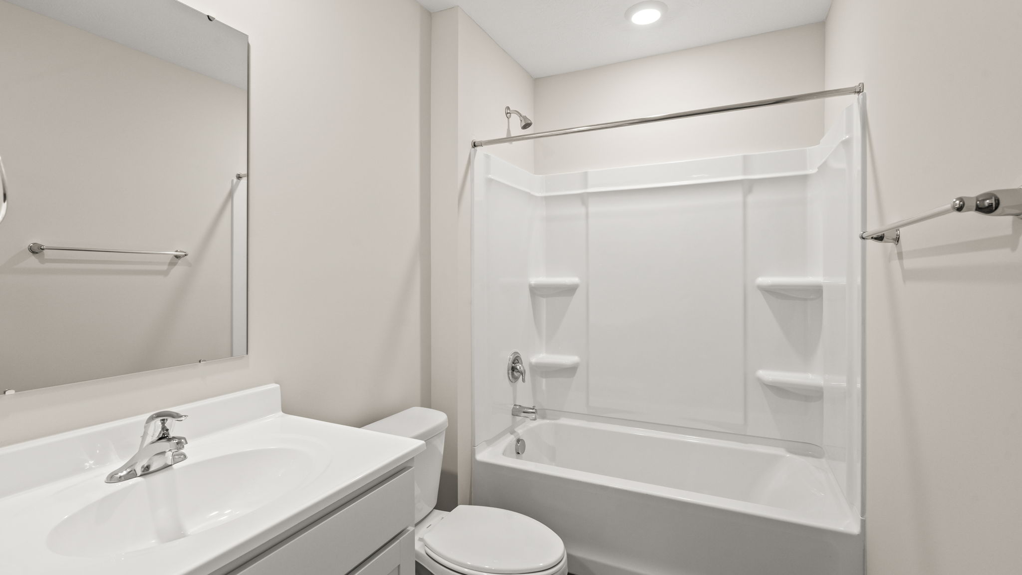 Bathroom with single sink vanity and step in shower.