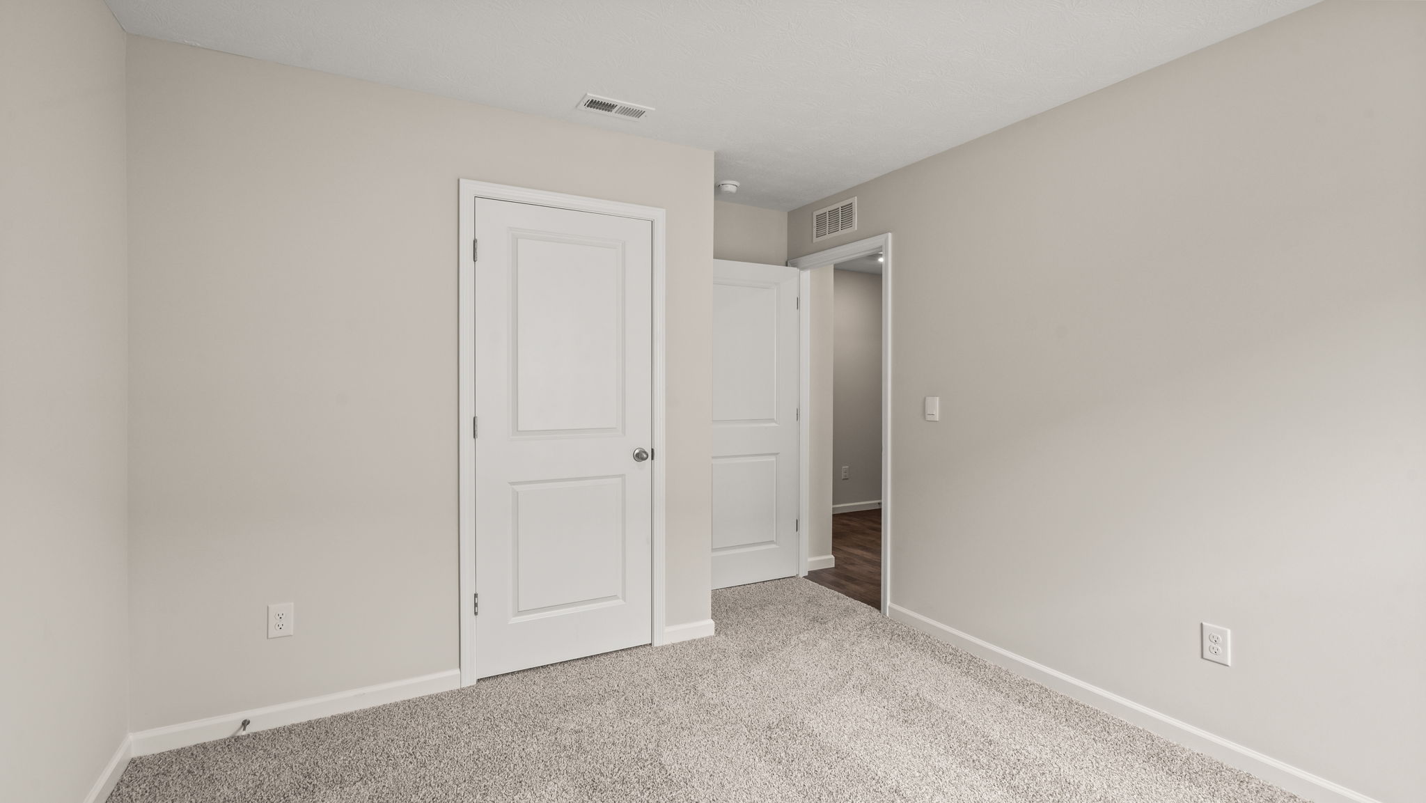 Bedroom with carpeted floors.
