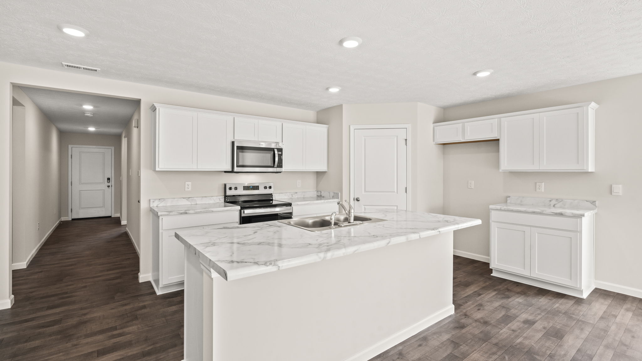 Kitchen with large kitchen island and laminate countertops.