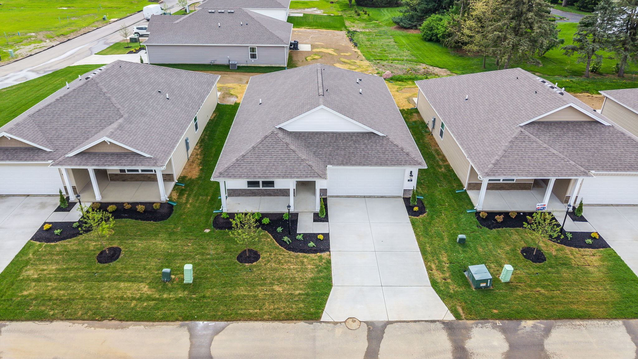 Aerial view of home with landscaping.