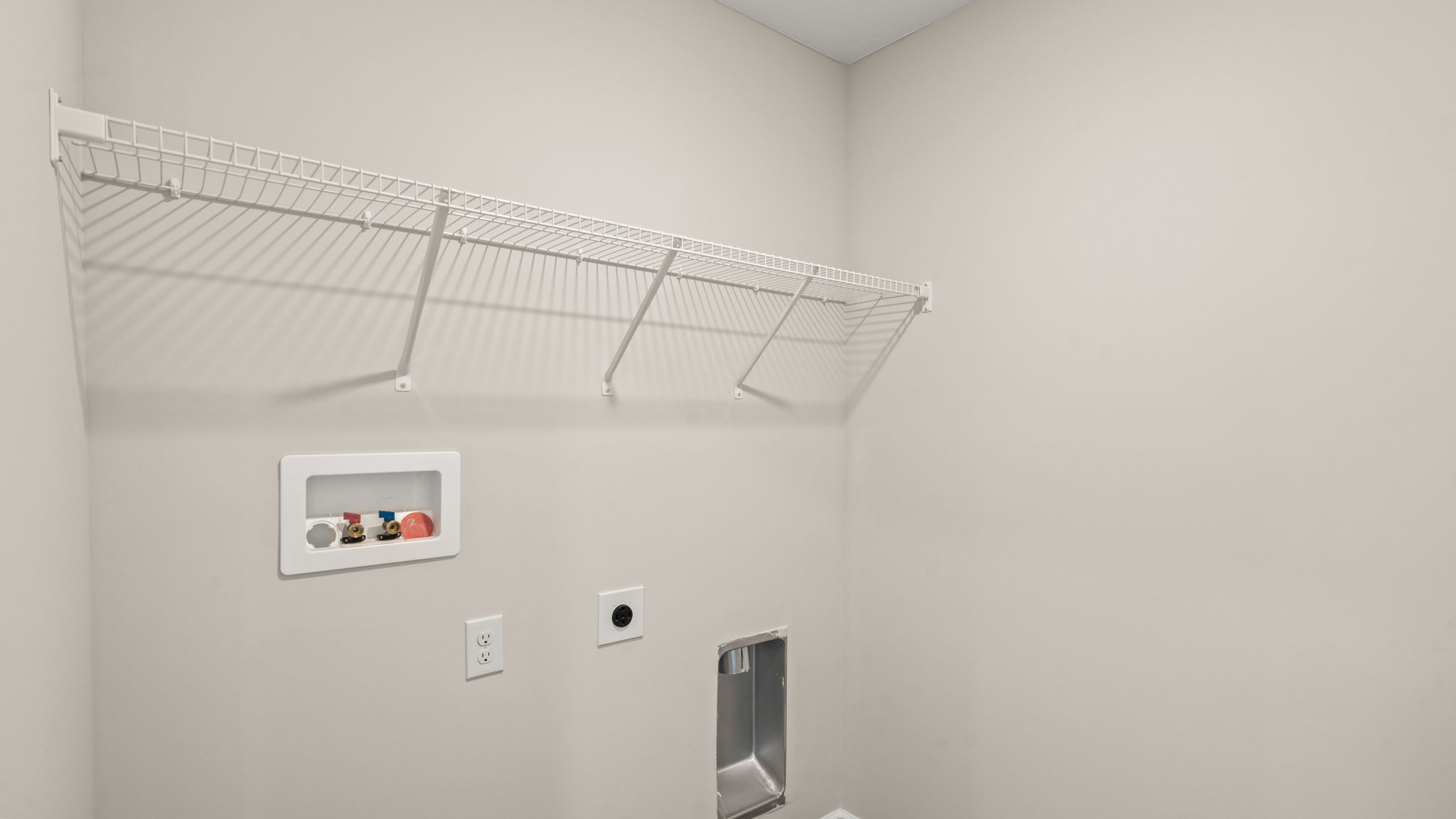 Laundry room with hanging storage and tile flooring.
