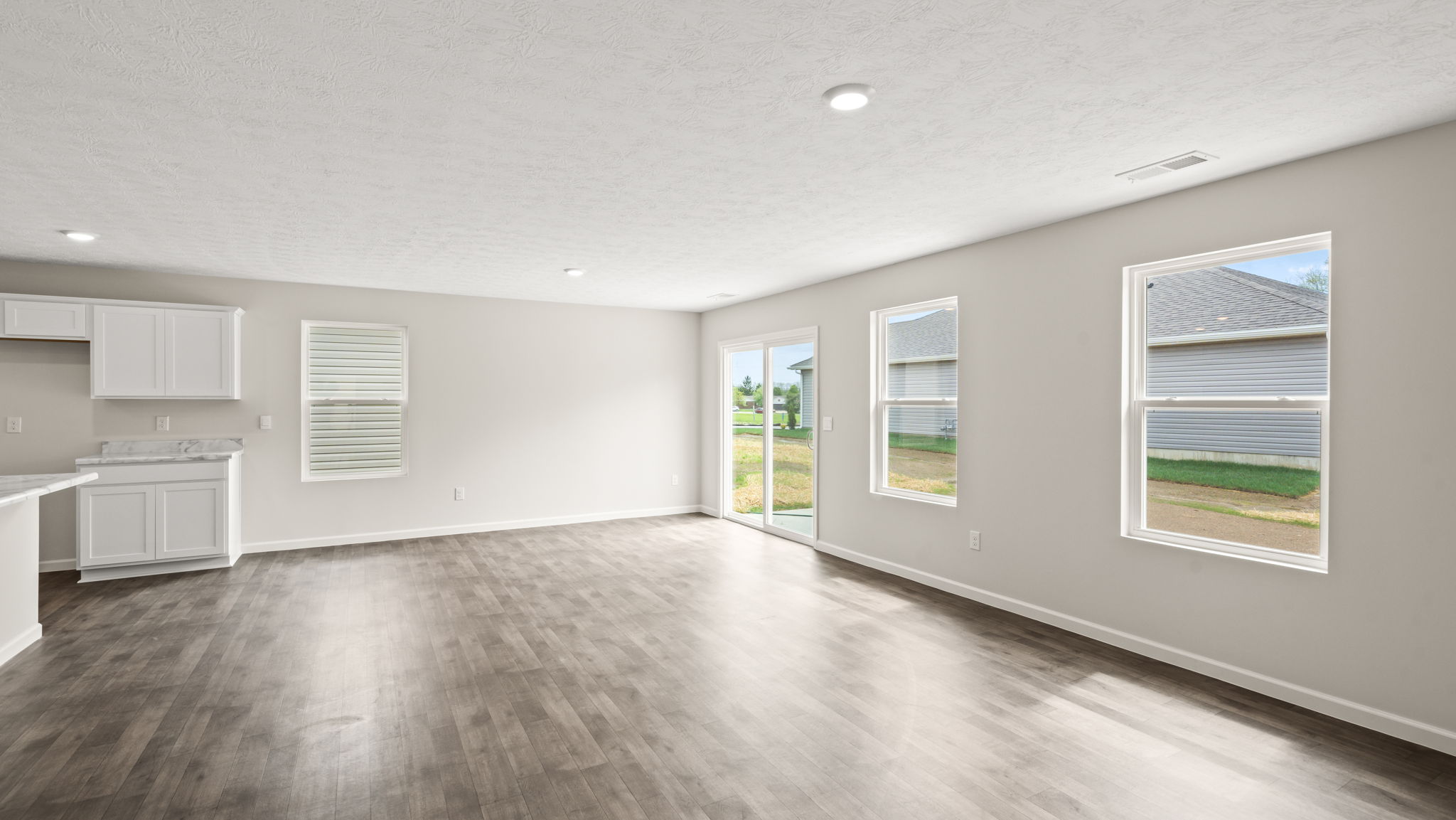 Living room with several window for natural lighting.