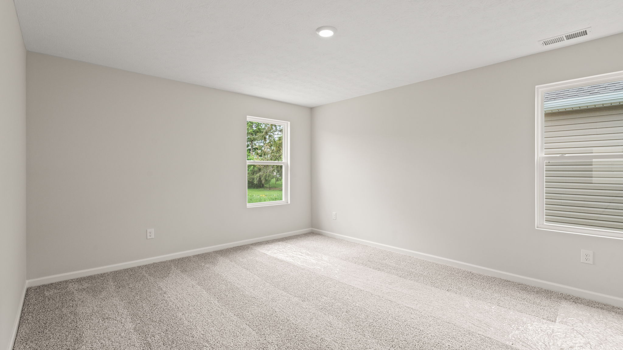Bedroom with two windows.