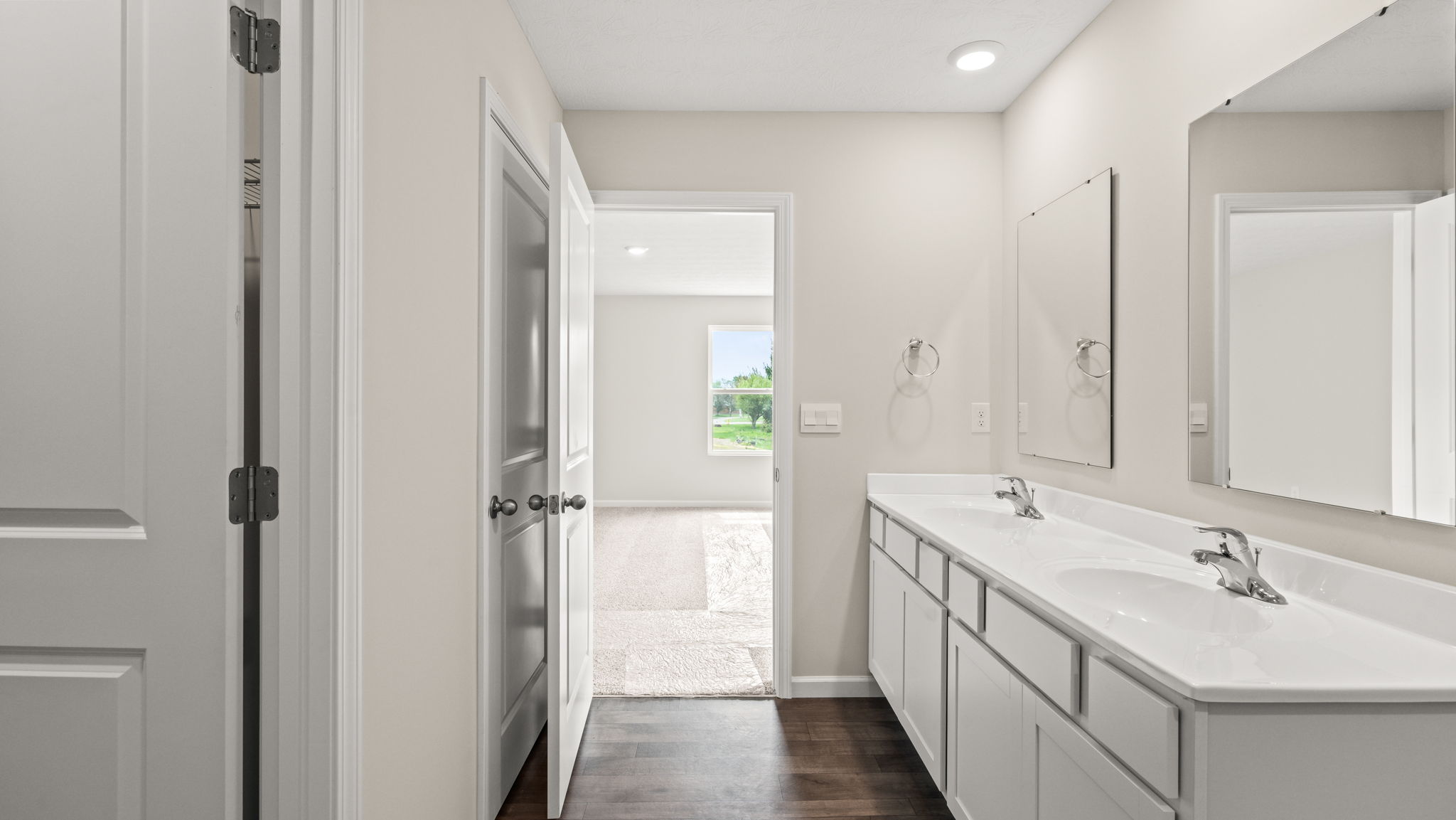 Bathroom with white countertops and cabinets.