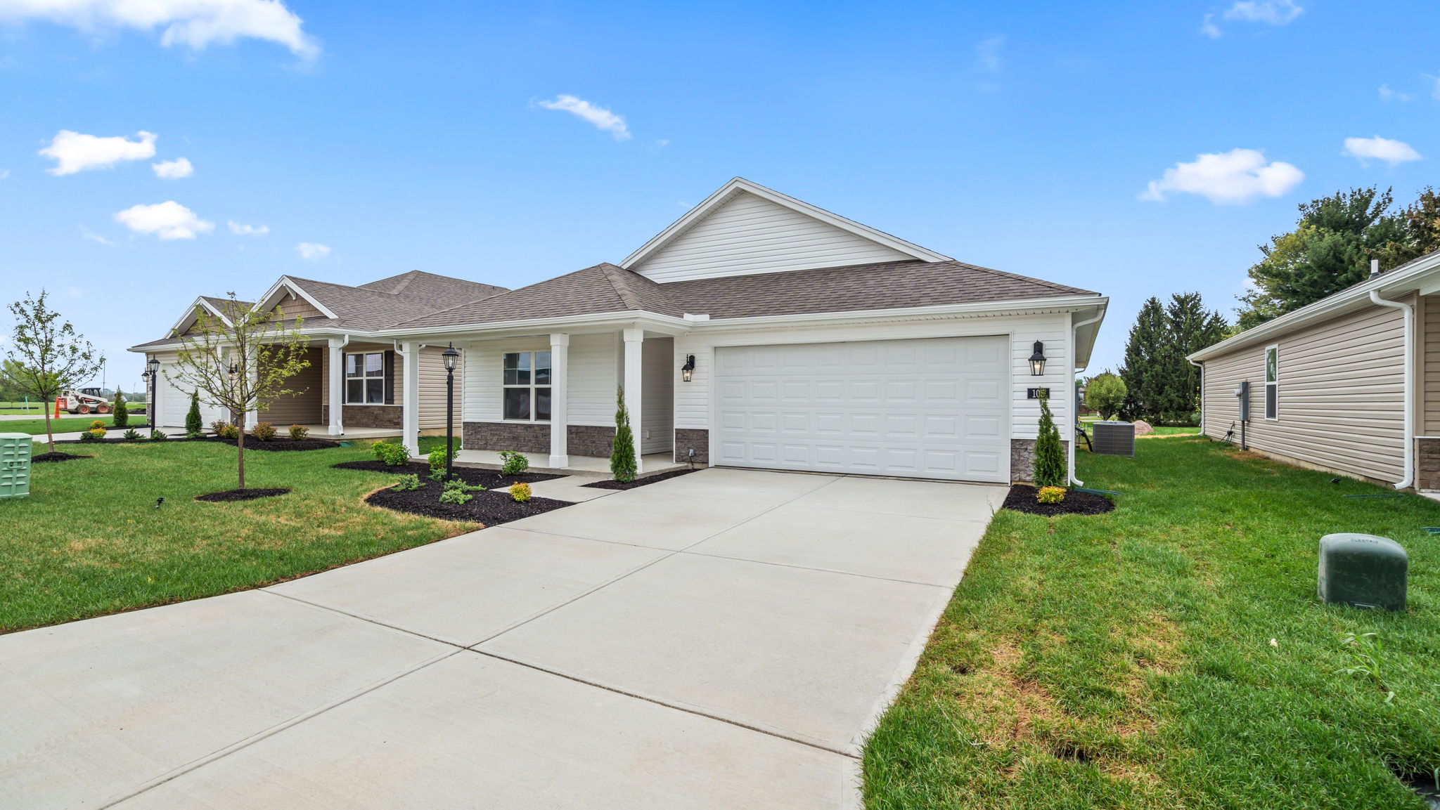Front exterior of home with partial brick siding.
