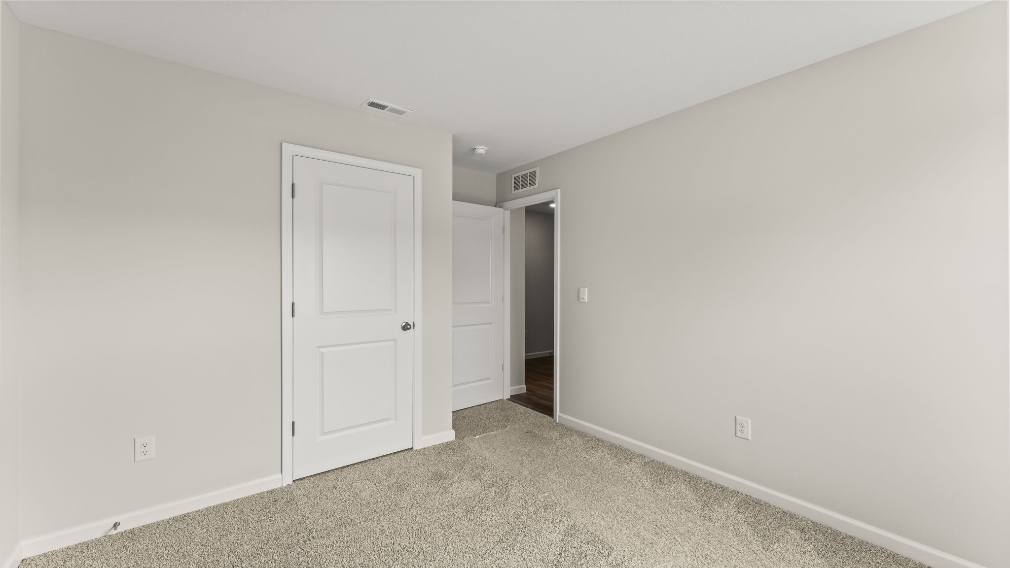 Bedroom with carpeted floors and a large closet.